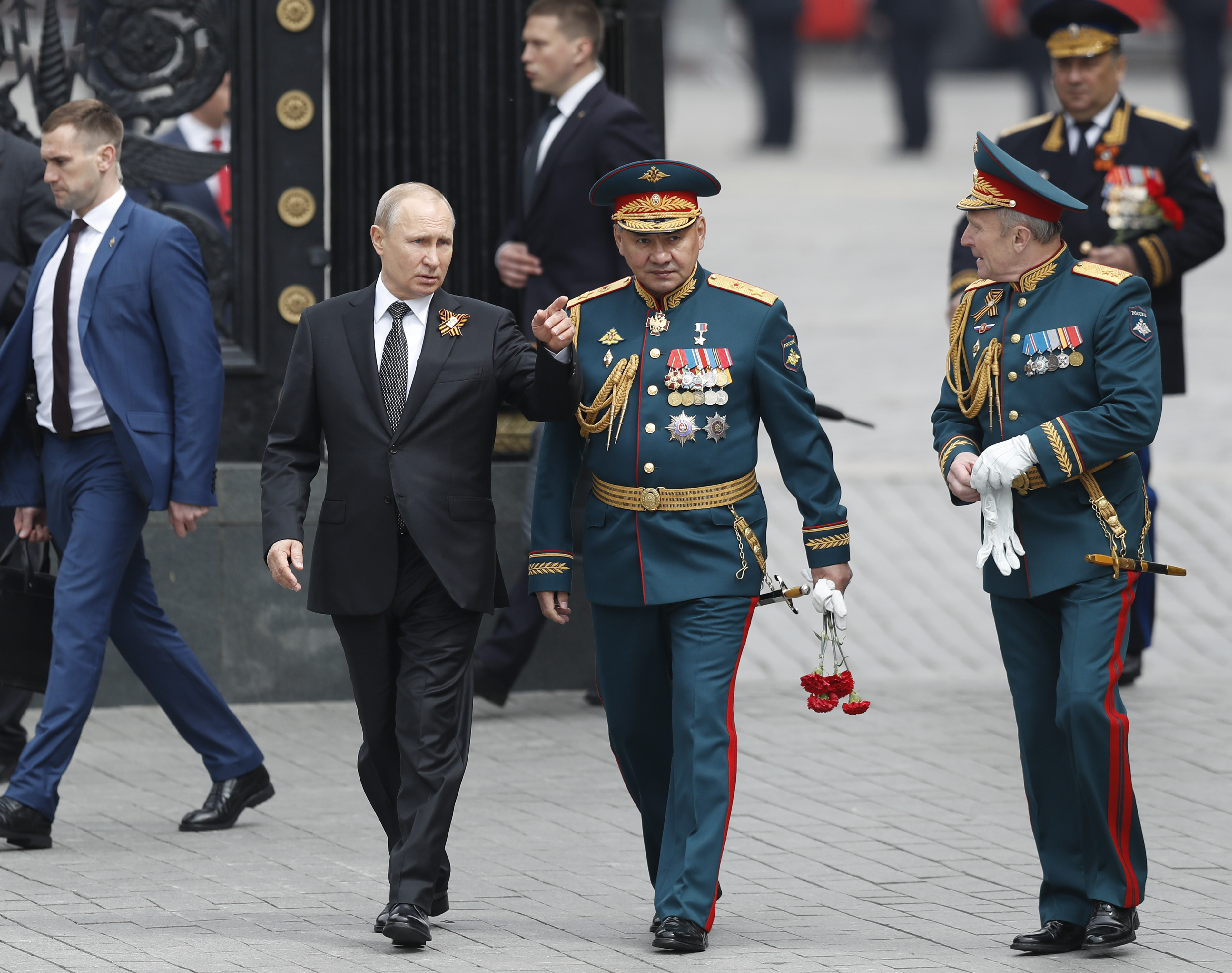 Russian President Vladimir Putin, centre left, Russian Defense Minister Sergei Shoigu, center, and Commander-in-Chief of the Graund Forces and Victory Parade Commander Colonel-General Oleg Salyukov, right, walk to attend a wreath-laying ceremony at the Tomb of the Unknown Soldier after the military parade marking 74 years since the victory in WWII in Moscow, Russia, Thursday, May 9, 2019. (AP Photo/Pavel Golovkin)