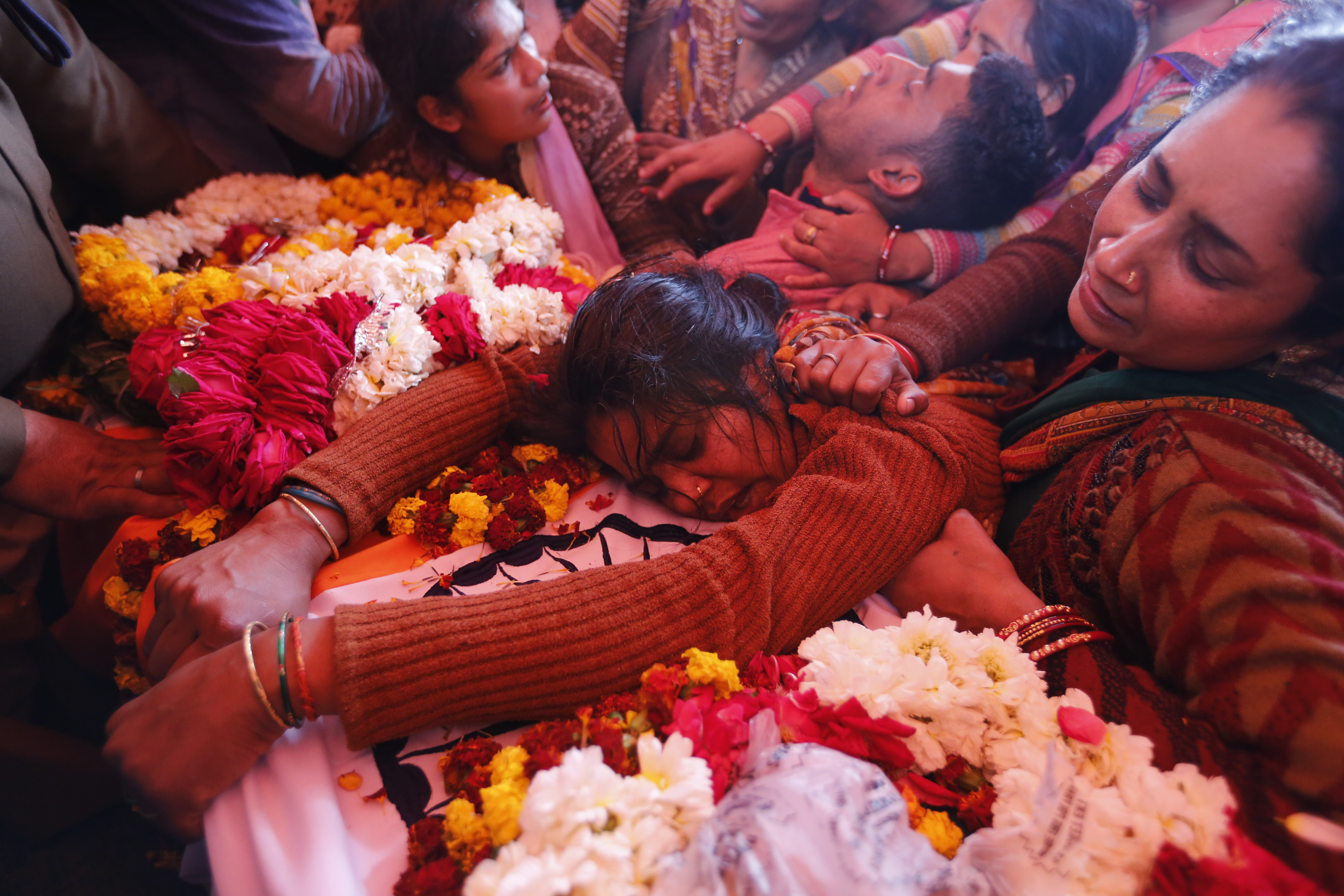 Sanjana cries over the body of her husband Mahesh Yadav, a Central Reserve Police Force (CRPF) soldier who was killed in Thursday bombing in Kashmir, in Tudihar village, some 56 kilometers east of Prayagraj, Uttar Pradesh state, India, Saturday, Feb. 16, 2019. As India considers its response to the suicide car bombing of a paramilitary convoy in Kashmir that killed dozens of soldiers, a retired military commander who oversaw a much-lauded military strike against neighboring Pakistan in 2016 has urged caution. (AP Photo/ Rajesh Kumar Singh) Sanjana cries over the body of her husband Mahesh Yadav, a Central Reserve Police Force (CRPF) soldier who was killed in Thursday bombing in Kashmir, in Tudihar village, some 56 kilometers east of Prayagraj, Uttar Pradesh state, India, Saturday, Feb. 16, 2019. As India considers its response to the suicide car bombing of a paramilitary convoy in Kashmir that killed dozens of soldiers, a retired military commander who oversaw a much-lauded military strike against neighboring Pakistan in 2016 has urged caution. (AP Photo/ Rajesh Kumar Singh)