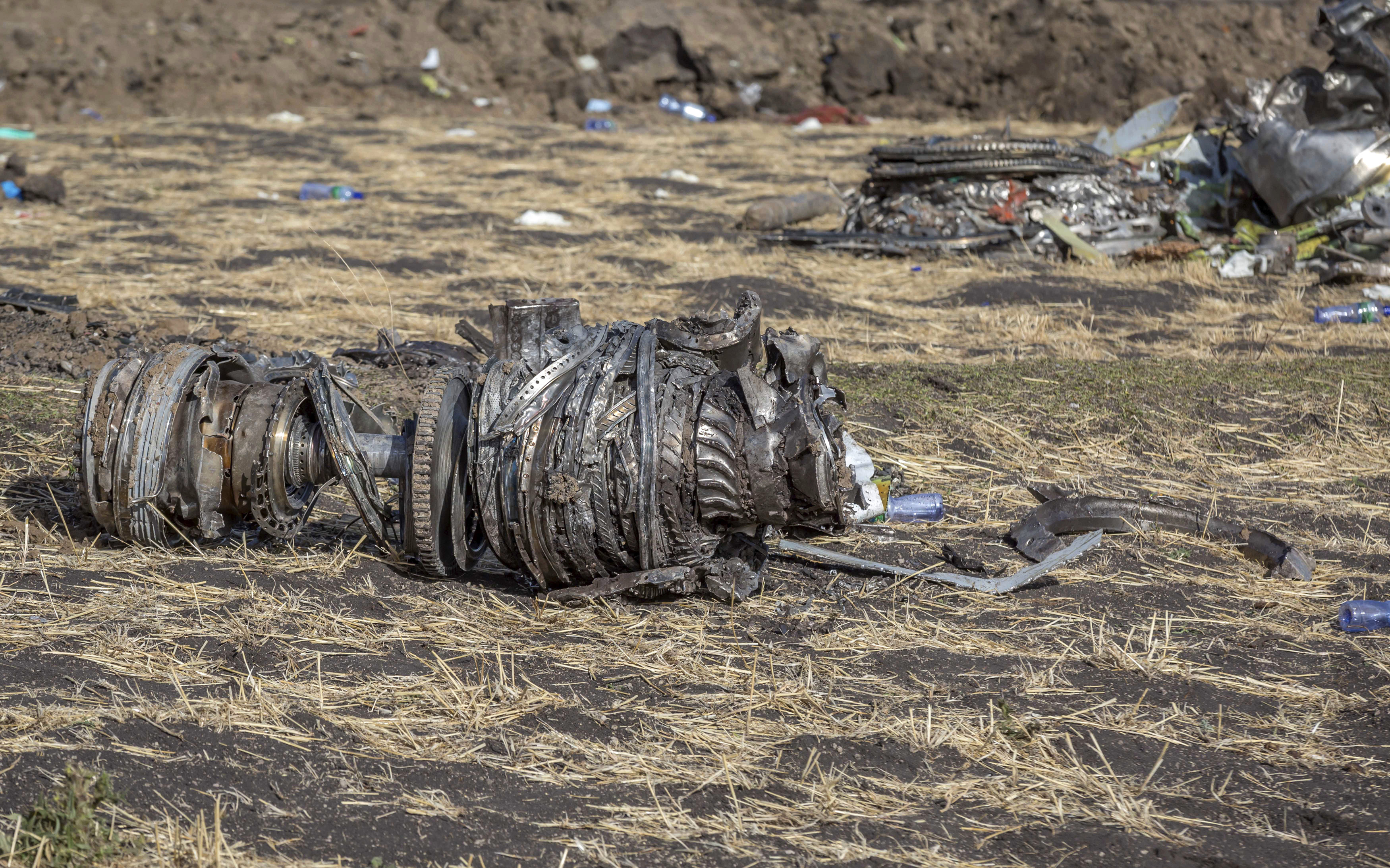 FILE- In this March 11, 2019, file photo airplane parts lie on the ground at the scene of an Ethiopian Airlines flight crash near Bishoftu, or Debre Zeit, south of Addis Ababa, Ethiopia. Investigators have determined that an anti-stall system automatically activated before the Ethiopian Airlines Boeing 737 Max jet plunged into the ground, The Wall Street Journal reported Friday, March 29. (AP Photo/Mulugeta Ayene, File)