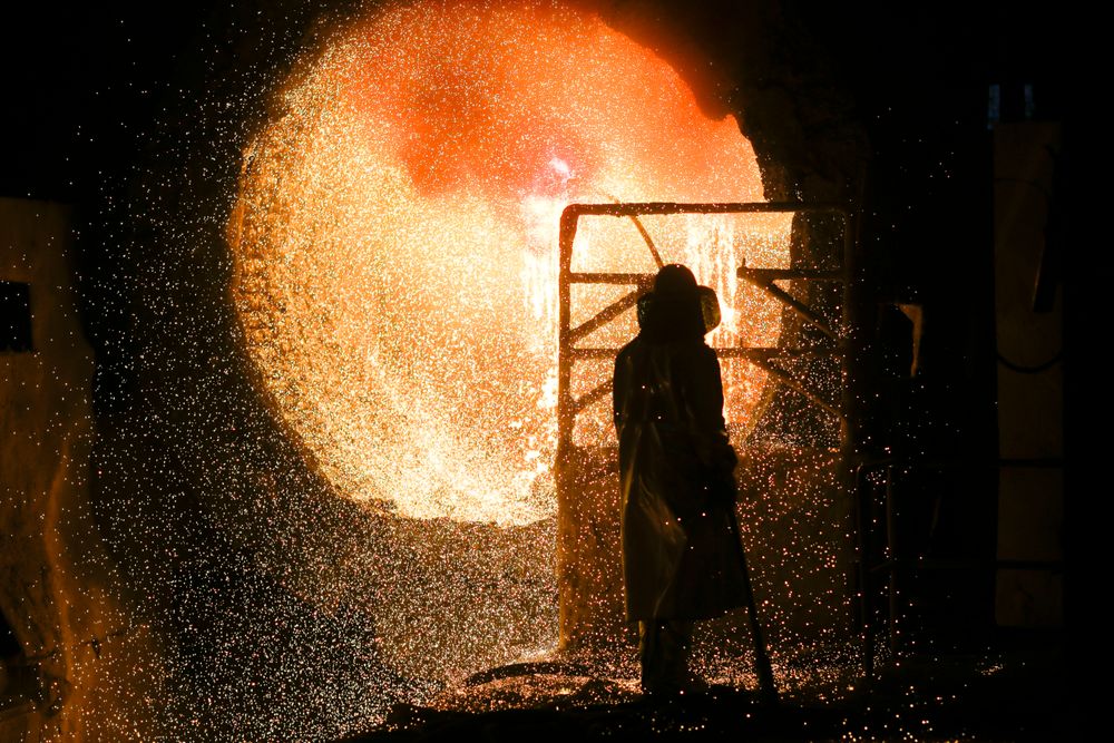 File - In this Tuesday, March 5, 2019, file photo, an employee in protective clothing works with a steel pouring ladle during a guided media tour at the steel producer Salzgitter AG in Salzgitter. The German economy shrank by 0.1 percent in the second quarter from the previous quarter as global trade conflicts and troubles in the auto industry weighed on Europe's largest economy. (AP Photo/Markus Schreiber) File - In this Tuesday, March 5, 2019, file photo, an employee in protective clothing works with a steel pouring ladle during a guided media tour at the steel producer Salzgitter AG in Salzgitter. The German economy shrank by 0.1 percent in the second quarter from the previous quarter as global trade conflicts and troubles in the auto industry weighed on Europe's largest economy. (AP Photo/Markus Schreiber)