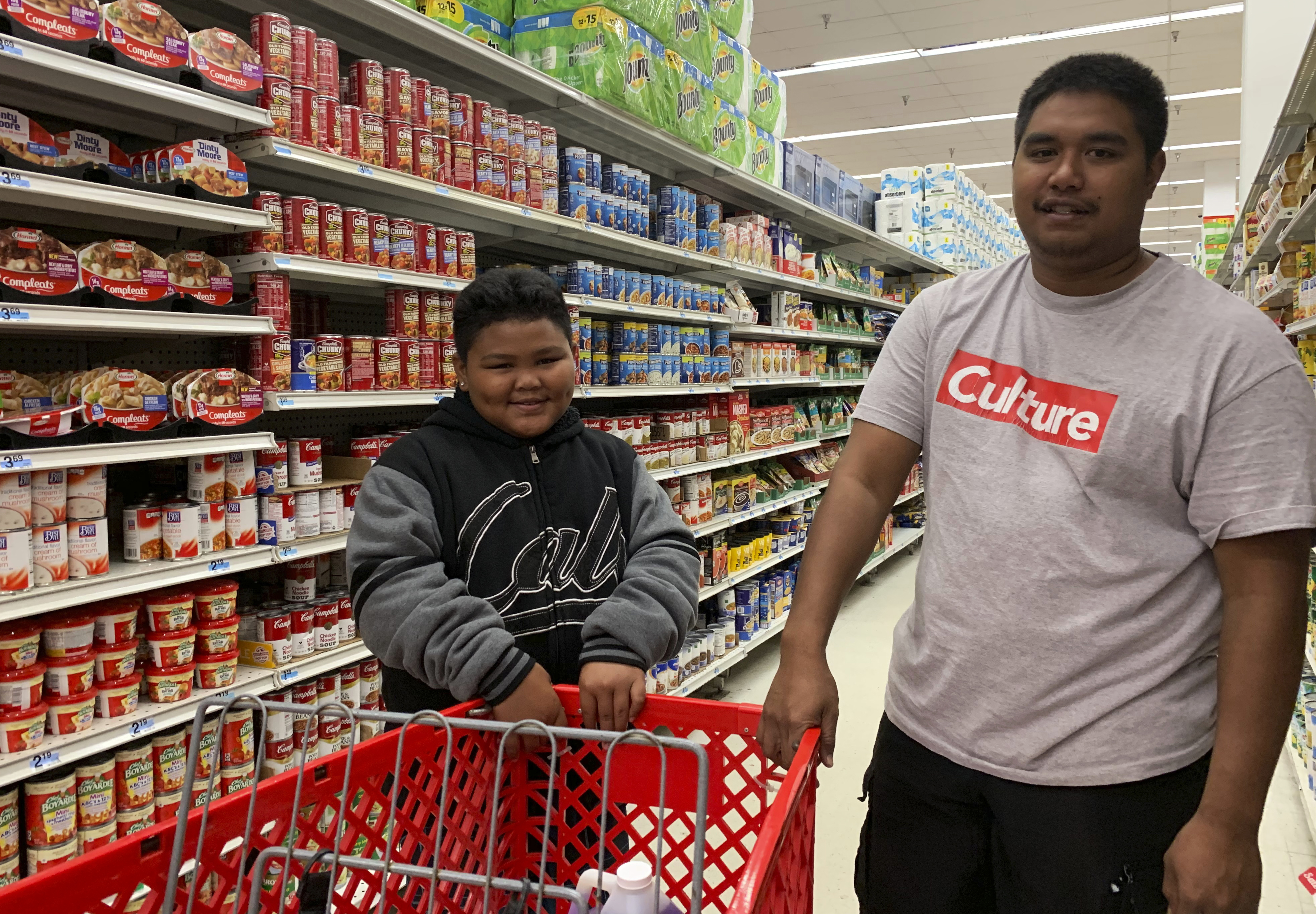 Tyrone Quinata, 23, and his nephew Rayden Gofigan, 11, shop for batteries and other necessities in Tamuning, Guam on Thursday, Feb. 21, 2019. An intensifying tropical storm in the Pacific is bearing down on Micronesia and could threaten the U.S. territory of Guam in the coming days. (AP Photo/Grace Garces Bordallo) Tyrone Quinata, 23, and his nephew Rayden Gofigan, 11, shop for batteries and other necessities in Tamuning, Guam on Thursday, Feb. 21, 2019. An intensifying tropical storm in the Pacific is bearing down on Micronesia and could threaten the U.S. territory of Guam in the coming days. (AP Photo/Grace Garces Bordallo)