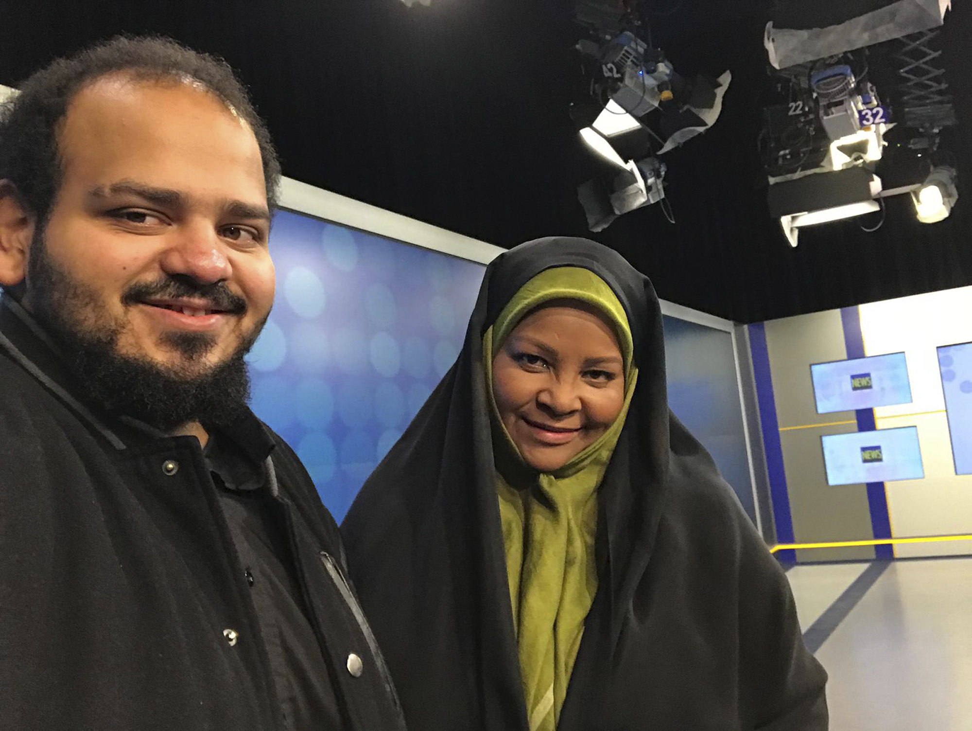 In this undated photo provided by Iranian state television's English-language service, Press TV, American-born news anchor Marzieh Hashemi, right, smiles as she stands with her son in Tehran, Iran. The elder son of Hashemi says his mother is being held in the United States, but has not been charged with anything. Hussein Hashemi says she was detained Sunday, Jan. 13, 2019, as she was leaving St. Louis for Denver. He says she had filmed a Black Lives Matter documentary in St. Louis after visiting family in New Orleans. (Press TV via AP) In this undated photo provided by Iranian state television's English-language service, Press TV, American-born news anchor Marzieh Hashemi, right, smiles as she stands with her son in Tehran, Iran. The elder son of Hashemi says his mother is being held in the United States, but has not been charged with anything. Hussein Hashemi says she was detained Sunday, Jan. 13, 2019, as she was leaving St. Louis for Denver. He says she had filmed a Black Lives Matter documentary in St. Louis after visiting family in New Orleans. (Press TV via AP)