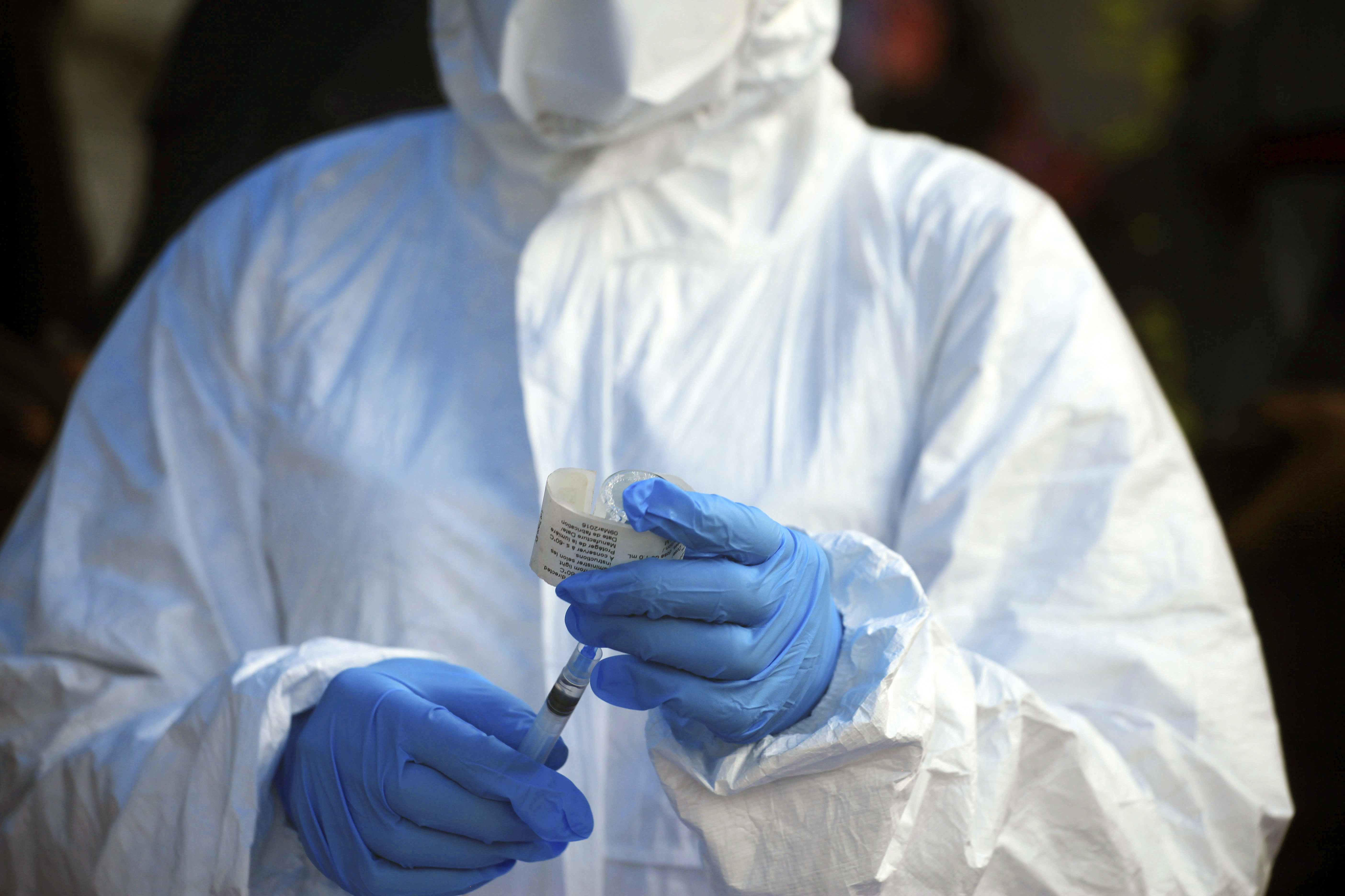 FILE - In this file photo dated Wednesday, Aug 8, 2018, a healthcare worker from the World Health Organization prepares to give an Ebola vaccination in Mangina, Democratic Republic of Congo. Armed assailants attacked an Ebola treatment center in Butembo, in the heart of eastern Congo’s deadly outbreak on Saturday March 9, 2019, with the mayor reporting one police officer killed. (AP Photo/Al-hadji Kudra Maliro, FILE) FILE - In this file photo dated Wednesday, Aug 8, 2018, a healthcare worker from the World Health Organization prepares to give an Ebola vaccination in Mangina, Democratic Republic of Congo. Armed assailants attacked an Ebola treatment center in Butembo, in the heart of eastern Congo’s deadly outbreak on Saturday March 9, 2019, with the mayor reporting one police officer killed. (AP Photo/Al-hadji Kudra Maliro, FILE)