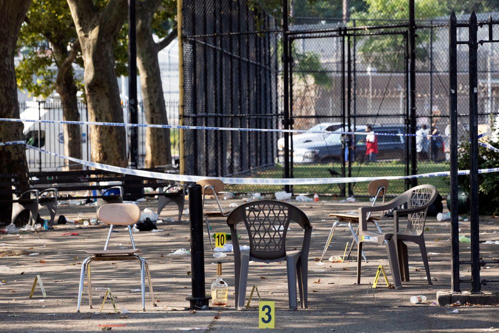 Yellow evidence markers are placed next to chairs at a playground in the Brownsville neighborhood in the Brooklyn borough of New York, Sunday, July 28, 2019. Police said, one man was killed and at least 11 others were injured in a shooting late Saturday night at the park. (AP Photo/Mark Lennihan) Yellow evidence markers are placed next to chairs at a playground in the Brownsville neighborhood in the Brooklyn borough of New York, Sunday, July 28, 2019. Police said, one man was killed and at least 11 others were injured in a shooting late Saturday night at the park. (AP Photo/Mark Lennihan)