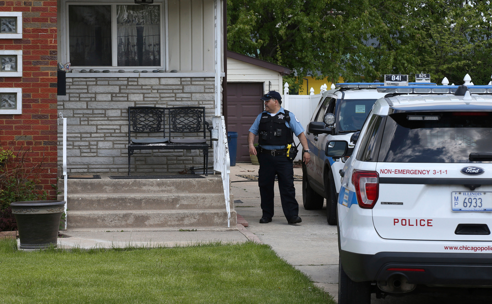 CORRECTS VICTIM'S LAST NAME TO OCHOA-LOPEZ INSTEAD OF OCHOA-URIOSTEGUI - Chicago police watch over a home in Chicago, Wednesday, May 15, 2019, where Marlen Ochoa-Lopez was found strangled and her baby cut from her womb. Police and family members said Ochoa-Lopez went to the home in response to a Facebook offer of free baby clothes. (Terrence Antonio James/Chicago Tribune via AP) CORRECTS VICTIM'S LAST NAME TO OCHOA-LOPEZ INSTEAD OF OCHOA-URIOSTEGUI - Chicago police watch over a home in Chicago, Wednesday, May 15, 2019, where Marlen Ochoa-Lopez was found strangled and her baby cut from her womb. Police and family members said Ochoa-Lopez went to the home in response to a Facebook offer of free baby clothes. (Terrence Antonio James/Chicago Tribune via AP)