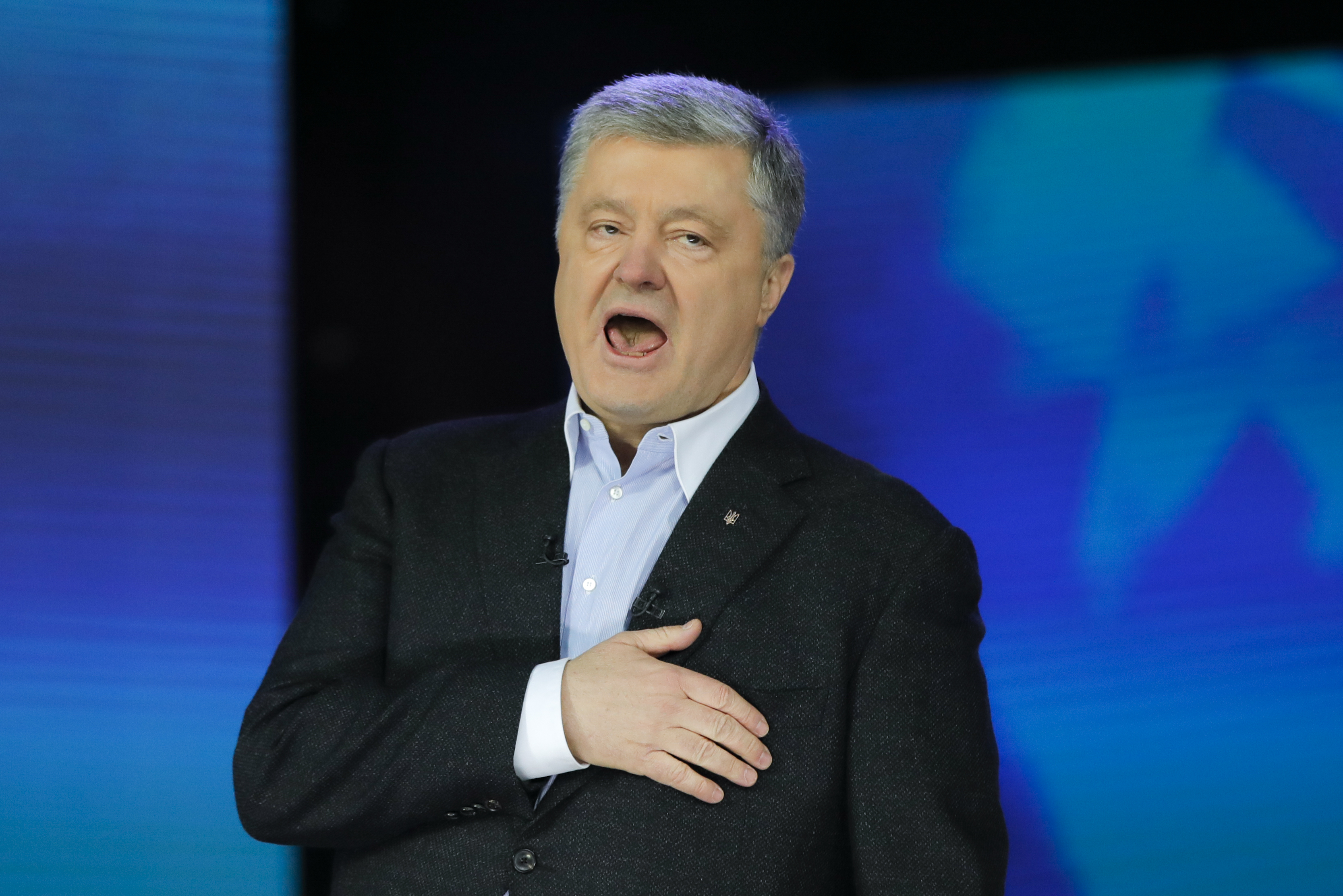 Ukrainian President Petro Poroshenko sings the national anthem after debates between two candidates in the weekend presidential run-off at the Olympic stadium in Kiev, Ukraine, Friday, April 19, 2019. Friday is the last official day of election canvassing in Ukraine as all presidential candidates and their campaigns will be barred from campaigning on Saturday, the day before the vote. (AP Photo/Vadim Ghirda) Ukrainian President Petro Poroshenko sings the national anthem after debates between two candidates in the weekend presidential run-off at the Olympic stadium in Kiev, Ukraine, Friday, April 19, 2019. Friday is the last official day of election canvassing in Ukraine as all presidential candidates and their campaigns will be barred from campaigning on Saturday, the day before the vote. (AP Photo/Vadim Ghirda)