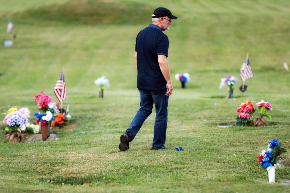 Eddie Davis walks past tributes on his way to his son Jeremy's gravestone, who died from the abuse of opioids, Wednesday, July 17, 2019, in Coalton, Ohio. Newly released prescription opioid statistics underscore how widespread pill use has been in towns and small cities of America’s Appalachian region. In Jackson County, an average yearly total of 107 opioid pills for every resident were distributed over a seven-year period. (AP Photo/John Minchillo) Eddie Davis walks past tributes on his way to his son Jeremy's gravestone, who died from the abuse of opioids, Wednesday, July 17, 2019, in Coalton, Ohio. Newly released prescription opioid statistics underscore how widespread pill use has been in towns and small cities of America’s Appalachian region. In Jackson County, an average yearly total of 107 opioid pills for every resident were distributed over a seven-year period. (AP Photo/John Minchillo)