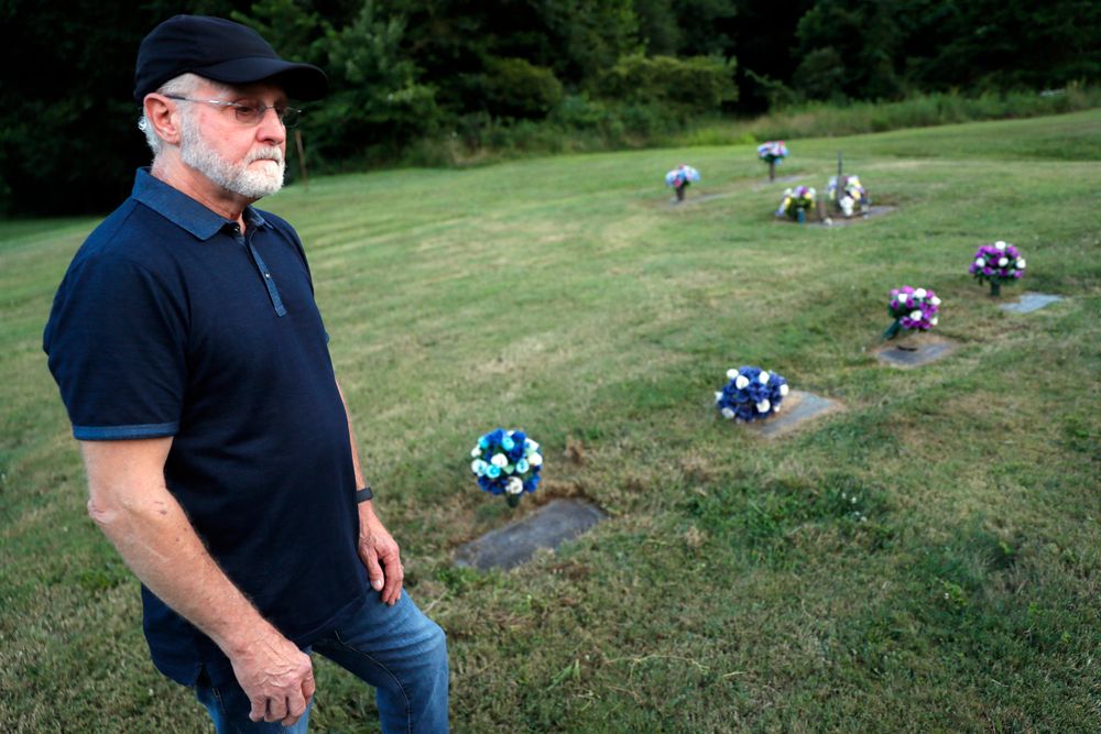 Eddie Davis stands beside the gravestone of his son Jeremy, furthest left, who died from the abuse of opioids, Wednesday, July 17, 2019, in Coalton, Ohio. Members of his family are buried in adjacent plots, including his parents and a sibling. (AP Photo/John Minchillo) Eddie Davis stands beside the gravestone of his son Jeremy, furthest left, who died from the abuse of opioids, Wednesday, July 17, 2019, in Coalton, Ohio. Members of his family are buried in adjacent plots, including his parents and a sibling. (AP Photo/John Minchillo)