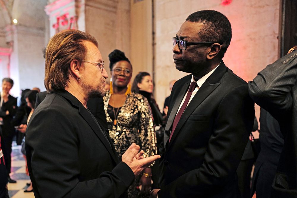Senegalese singer Youssou N'dour, right, speaks with Irish rock band U2 singer Bono at the City Hall of Lyon, central France, Wednesday Oct.9 2019, ahead of the two-day conference of Global Fund to Fight HIV, Tuberculosis and Malaria. (Olivier Chassignole, Pool via AP) Senegalese singer Youssou N'dour, right, speaks with Irish rock band U2 singer Bono at the City Hall of Lyon, central France, Wednesday Oct.9 2019, ahead of the two-day conference of Global Fund to Fight HIV, Tuberculosis and Malaria. (Olivier Chassignole, Pool via AP)
