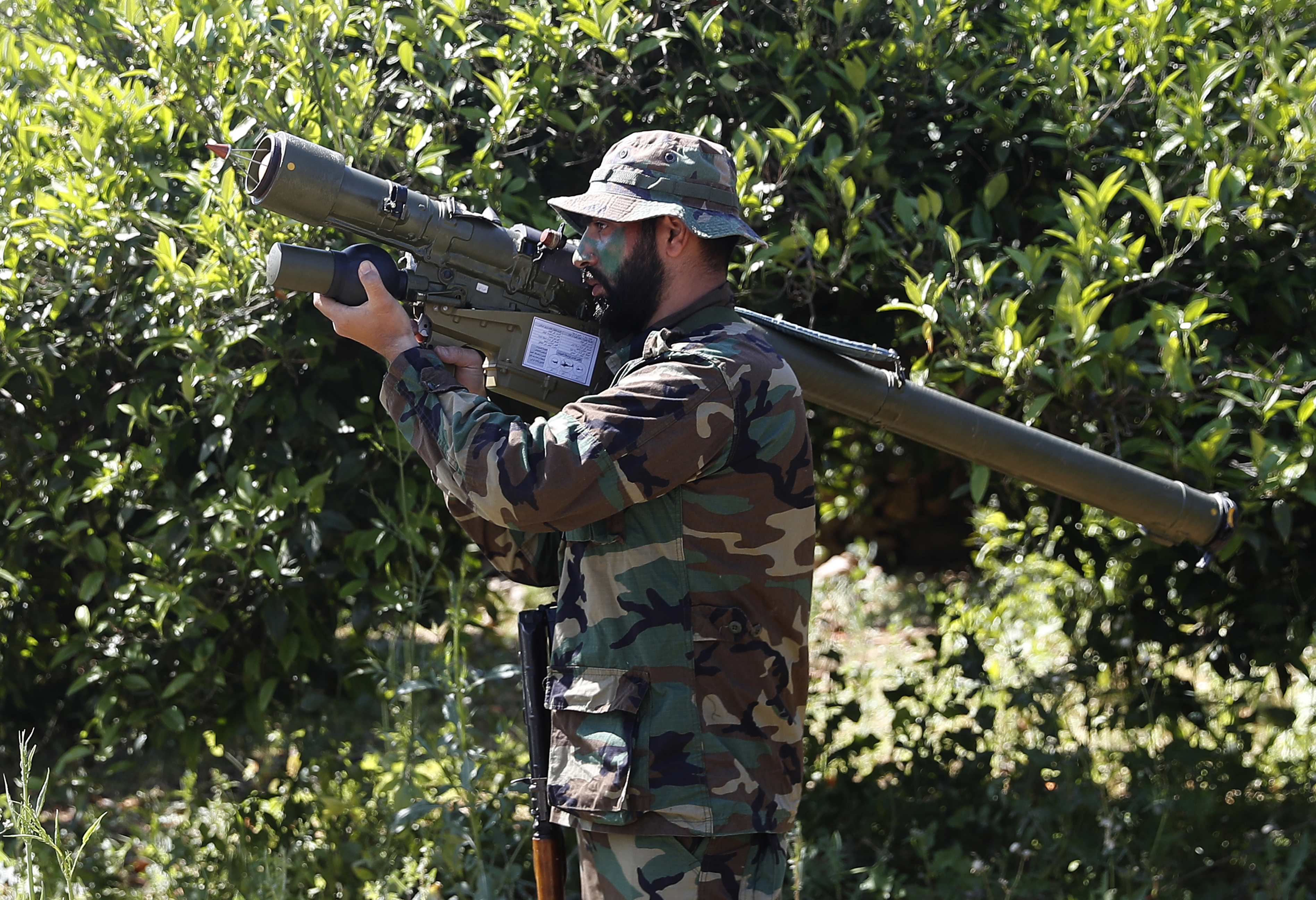 FILE - This April 20, 2017 file photo, shows a Hezbollah fighter holding an Iranian-made anti-aircraft missile on the border with Israel, in Naqoura, south Lebanon. The British government will make inciting support for Hezbollah a criminal offense as senior officials accused the Iran-backed organization of destabilizing the Middle East. (AP Photo/Hussein Malla, File) FILE - This April 20, 2017 file photo, shows a Hezbollah fighter holding an Iranian-made anti-aircraft missile on the border with Israel, in Naqoura, south Lebanon. The British government will make inciting support for Hezbollah a criminal offense as senior officials accused the Iran-backed organization of destabilizing the Middle East. (AP Photo/Hussein Malla, File)