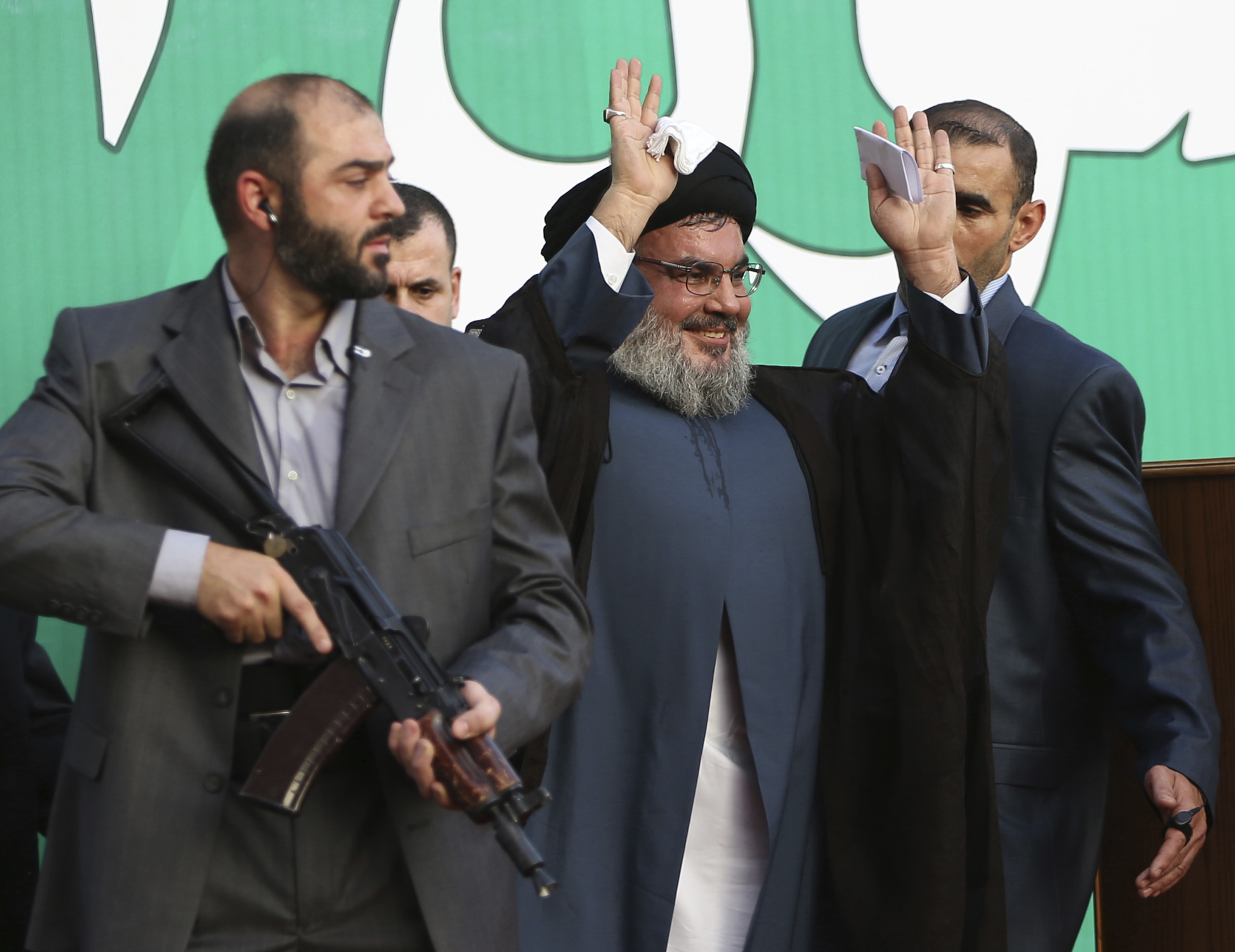 FILE - In this Sept 17, 2012 file photo, Hezbollah leader Sheik Hassan Nasrallah, center, escorted by his bodyguards, waves to a crowd of tens of thousands of supporters during a rally denouncing an anti-Islam film that has provoked a week of unrest in Muslim countries worldwide, in a southern suburb of Beirut, Lebanon. The British government will make inciting support for Hezbollah a criminal offense as senior officials accused the Iran-backed organization of destabilizing the Middle East. (AP Photo/Hussein Malla, File) FILE - In this Sept 17, 2012 file photo, Hezbollah leader Sheik Hassan Nasrallah, center, escorted by his bodyguards, waves to a crowd of tens of thousands of supporters during a rally denouncing an anti-Islam film that has provoked a week of unrest in Muslim countries worldwide, in a southern suburb of Beirut, Lebanon. The British government will make inciting support for Hezbollah a criminal offense as senior officials accused the Iran-backed organization of destabilizing the Middle East. (AP Photo/Hussein Malla, File)