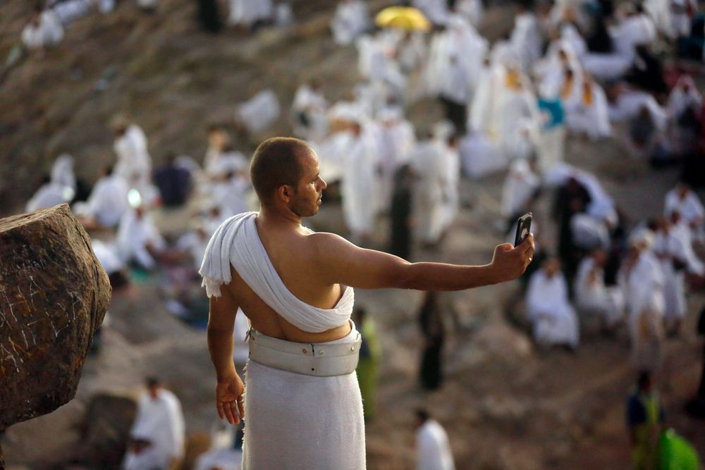 A Muslim pilgrim takes a selfie on a rocky hill known as Mountain of Mercy, on the Plain of Arafat, during the annual hajj pilgrimage, near the holy city of Mecca, Saudi Arabia, Saturday, Aug. 10, 2019. More than 2 million pilgrims were gathered to perform initial rites of the hajj, an Islamic pilgrimage that takes the faithful along a path traversed by the Prophet Muhammad some 1,400 years ago. (AP Photo/Amr Nabil) A Muslim pilgrim takes a selfie on a rocky hill known as Mountain of Mercy, on the Plain of Arafat, during the annual hajj pilgrimage, near the holy city of Mecca, Saudi Arabia, Saturday, Aug. 10, 2019. More than 2 million pilgrims were gathered to perform initial rites of the hajj, an Islamic pilgrimage that takes the faithful along a path traversed by the Prophet Muhammad some 1,400 years ago. (AP Photo/Amr Nabil)