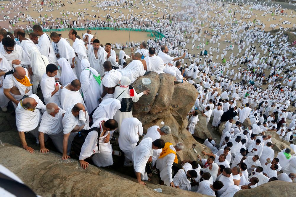 Muslim pilgrims make their way down on a rocky hill known as Mountain of Mercy, on the Plain of Arafat, during the annual hajj pilgrimage, near the holy city of Mecca, Saudi Arabia, Saturday, Aug. 10, 2019. More than 2 million pilgrims were gathered to perform initial rites of the hajj, an Islamic pilgrimage that takes the faithful along a path traversed by the Prophet Muhammad some 1,400 years ago. (AP Photo/Amr Nabil) Muslim pilgrims make their way down on a rocky hill known as Mountain of Mercy, on the Plain of Arafat, during the annual hajj pilgrimage, near the holy city of Mecca, Saudi Arabia, Saturday, Aug. 10, 2019. More than 2 million pilgrims were gathered to perform initial rites of the hajj, an Islamic pilgrimage that takes the faithful along a path traversed by the Prophet Muhammad some 1,400 years ago. (AP Photo/Amr Nabil)