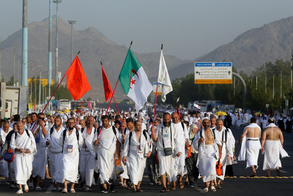 Algerian pilgrims march towards the Mountain of Mercy, on the Plain of Arafat, during the annual hajj pilgrimage, near the holy city of Mecca, Saudi Arabia, Saturday, Aug. 10, 2019. More than 2 million pilgrims were gathered to perform initial rites of the hajj, an Islamic pilgrimage that takes the faithful along a path traversed by the Prophet Muhammad some 1,400 years ago. (AP Photo/Amr Nabil) Algerian pilgrims march towards the Mountain of Mercy, on the Plain of Arafat, during the annual hajj pilgrimage, near the holy city of Mecca, Saudi Arabia, Saturday, Aug. 10, 2019. More than 2 million pilgrims were gathered to perform initial rites of the hajj, an Islamic pilgrimage that takes the faithful along a path traversed by the Prophet Muhammad some 1,400 years ago. (AP Photo/Amr Nabil)