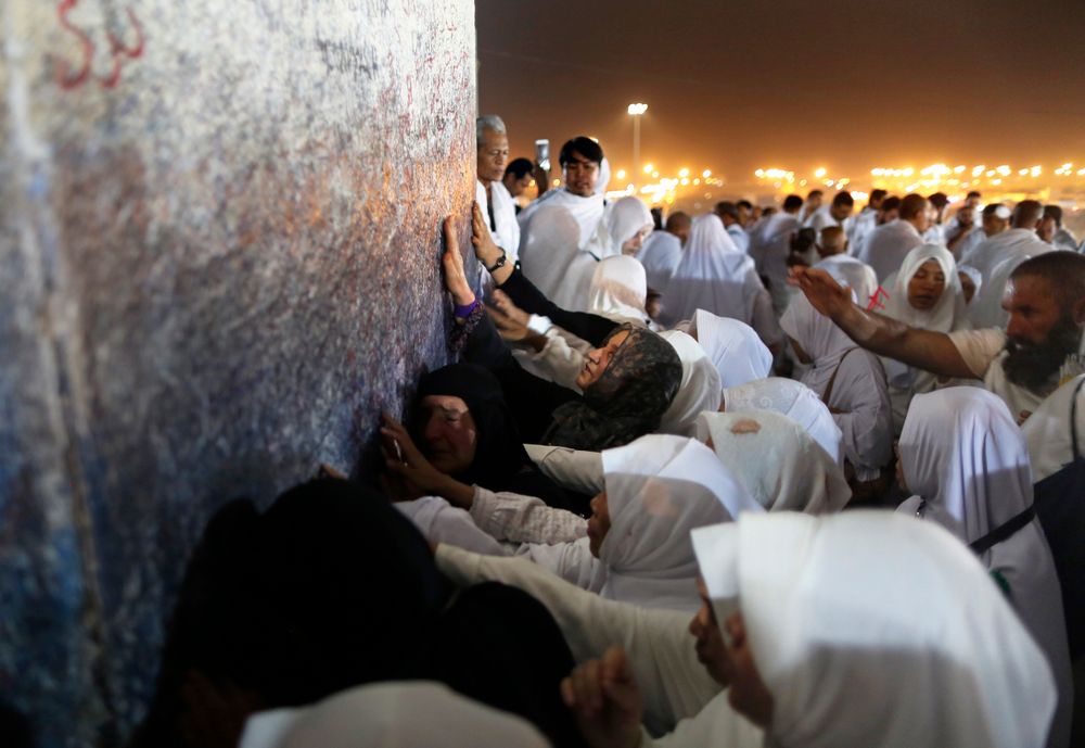 Muslim pilgrims pray in front of a pillar, where Islam's Prophet Muhammad is believed to have delivered his last sermon to tens of thousands of followers, on a rocky hill known as Mountain of Mercy, on the Plain of Arafat, during the annual hajj pilgrimage, ahead of sunrise near the holy city of Mecca, Saudi Arabia, Saturday, Aug. 10, 2019. More than 2 million pilgrims were gathered to perform initial rites of the hajj, an Islamic pilgrimage that takes the faithful along a path traversed by the Prophet Muhammad some 1,400 years ago. (AP Photo/Amr Nabil) Muslim pilgrims pray in front of a pillar, where Islam's Prophet Muhammad is believed to have delivered his last sermon to tens of thousands of followers, on a rocky hill known as Mountain of Mercy, on the Plain of Arafat, during the annual hajj pilgrimage, ahead of sunrise near the holy city of Mecca, Saudi Arabia, Saturday, Aug. 10, 2019. More than 2 million pilgrims were gathered to perform initial rites of the hajj, an Islamic pilgrimage that takes the faithful along a path traversed by the Prophet Muhammad some 1,400 years ago. (AP Photo/Amr Nabil)