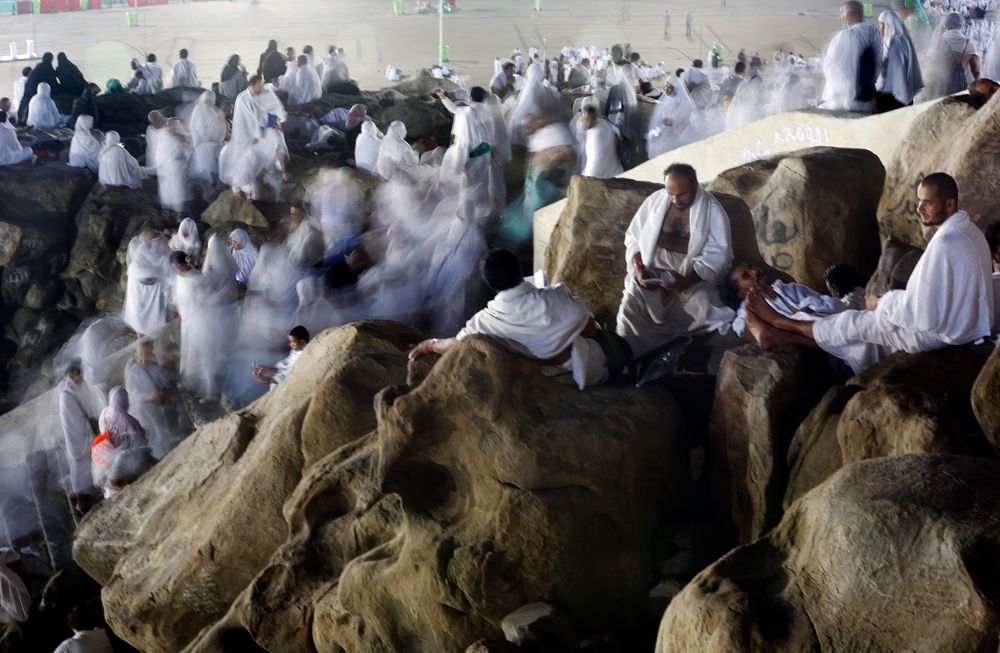 In this picture taken with low shutter speed, Muslim pilgrims make their way up on a rocky hill known as Mountain of Mercy, on the Plain of Arafat, during the annual hajj pilgrimage, ahead of sunrise near the holy city of Mecca, Saudi Arabia, Saturday, Aug. 10, 2019. More than 2 million pilgrims were gathered in the holy city of Mecca in Saudi Arabia on Friday to perform initial rites of the hajj, an Islamic pilgrimage that takes the faithful along a path traversed by the Prophet Muhammad some 1,400 years ago. (AP Photo/Amr Nabil) In this picture taken with low shutter speed, Muslim pilgrims make their way up on a rocky hill known as Mountain of Mercy, on the Plain of Arafat, during the annual hajj pilgrimage, ahead of sunrise near the holy city of Mecca, Saudi Arabia, Saturday, Aug. 10, 2019. More than 2 million pilgrims were gathered in the holy city of Mecca in Saudi Arabia on Friday to perform initial rites of the hajj, an Islamic pilgrimage that takes the faithful along a path traversed by the Prophet Muhammad some 1,400 years ago. (AP Photo/Amr Nabil)