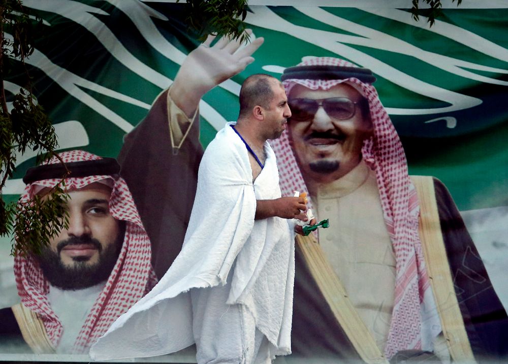 A Lebanese pilgrim walks in front of a banner showing Saudi King Salman, right, and his Crown Prince Mohammed bin Salman, near the Mountain of Mercy, on the Plain of Arafat, during the annual hajj pilgrimage, near the holy city of Mecca, Saudi Arabia, Saturday, Aug. 10, 2019. More than 2 million pilgrims were gathered to perform initial rites of the hajj, an Islamic pilgrimage that takes the faithful along a path traversed by the Prophet Muhammad some 1,400 years ago. (AP Photo/Amr Nabil) A Lebanese pilgrim walks in front of a banner showing Saudi King Salman, right, and his Crown Prince Mohammed bin Salman, near the Mountain of Mercy, on the Plain of Arafat, during the annual hajj pilgrimage, near the holy city of Mecca, Saudi Arabia, Saturday, Aug. 10, 2019. More than 2 million pilgrims were gathered to perform initial rites of the hajj, an Islamic pilgrimage that takes the faithful along a path traversed by the Prophet Muhammad some 1,400 years ago. (AP Photo/Amr Nabil)