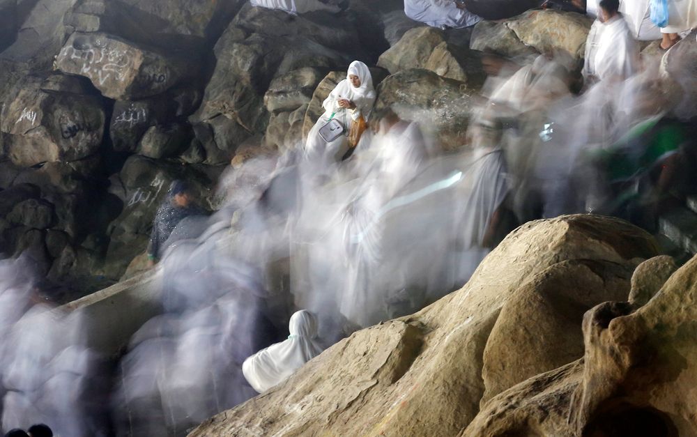 In this picture taken with low shutter speed, Muslim pilgrims make their way up on a rocky hill known as Mountain of Mercy, on the Plain of Arafat, during the annual hajj pilgrimage, ahead of sunrise near the holy city of Mecca, Saudi Arabia, Saturday, Aug. 10, 2019. More than 2 million pilgrims were gathered to perform initial rites of the hajj, an Islamic pilgrimage that takes the faithful along a path traversed by the Prophet Muhammad some 1,400 years ago. (AP Photo/Amr Nabil) In this picture taken with low shutter speed, Muslim pilgrims make their way up on a rocky hill known as Mountain of Mercy, on the Plain of Arafat, during the annual hajj pilgrimage, ahead of sunrise near the holy city of Mecca, Saudi Arabia, Saturday, Aug. 10, 2019. More than 2 million pilgrims were gathered to perform initial rites of the hajj, an Islamic pilgrimage that takes the faithful along a path traversed by the Prophet Muhammad some 1,400 years ago. (AP Photo/Amr Nabil)