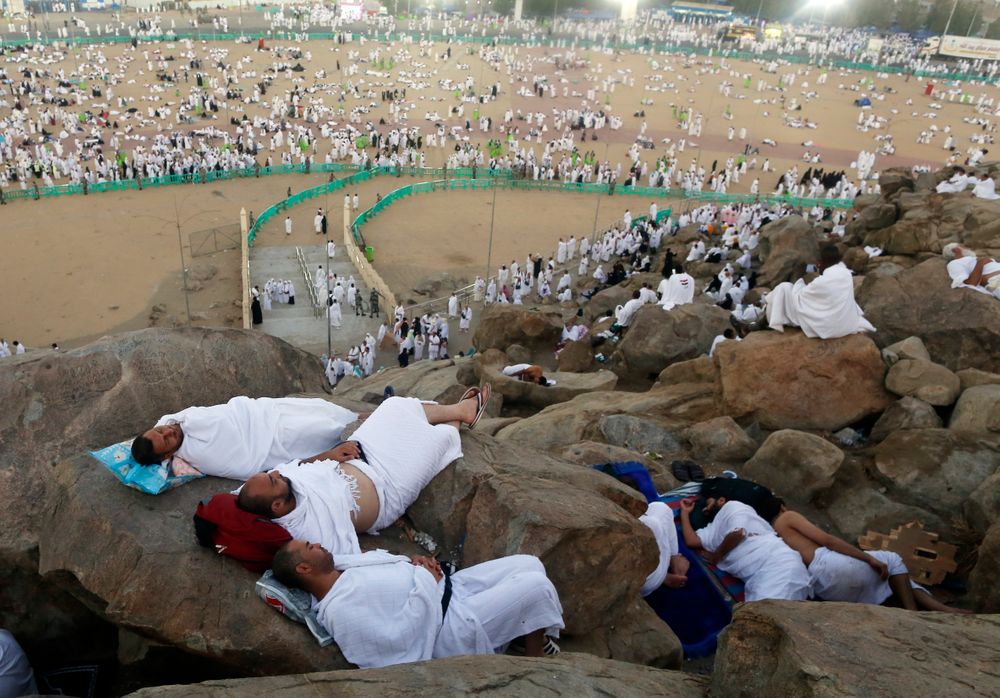 Muslim pilgrims take a nap on a rocky hill known as Mountain of Mercy, on the Plain of Arafat, during the annual hajj pilgrimage, ahead of sunrise near the holy city of Mecca, Saudi Arabia, Saturday, Aug. 10, 2019. More than 2 million pilgrims were gathered to perform initial rites of the hajj, an Islamic pilgrimage that takes the faithful along a path traversed by the Prophet Muhammad some 1,400 years ago. (AP Photo/Amr Nabil) Muslim pilgrims take a nap on a rocky hill known as Mountain of Mercy, on the Plain of Arafat, during the annual hajj pilgrimage, ahead of sunrise near the holy city of Mecca, Saudi Arabia, Saturday, Aug. 10, 2019. More than 2 million pilgrims were gathered to perform initial rites of the hajj, an Islamic pilgrimage that takes the faithful along a path traversed by the Prophet Muhammad some 1,400 years ago. (AP Photo/Amr Nabil)