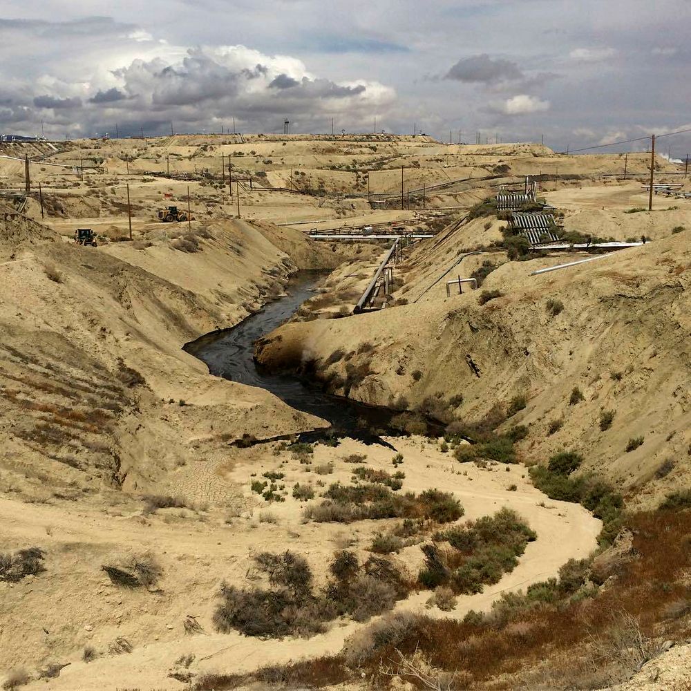 In this May 10, 2019 photo provided by the California Department of Fish and Wildlife's Office of Spill Prevention and Response, oil flows at a Chevron oil field in Kern County, Calif. Nearly 800,000 gallons of oil and water has seeped from the ground since May. Chevron and California officials say the spill is not near any waterway and has not significantly affected wildlife. (California Deptartment of Fish and Wildlife's Office of Spill Prevention and Response via AP) In this May 10, 2019 photo provided by the California Department of Fish and Wildlife's Office of Spill Prevention and Response, oil flows at a Chevron oil field in Kern County, Calif. Nearly 800,000 gallons of oil and water has seeped from the ground since May. Chevron and California officials say the spill is not near any waterway and has not significantly affected wildlife. (California Deptartment of Fish and Wildlife's Office of Spill Prevention and Response via AP)