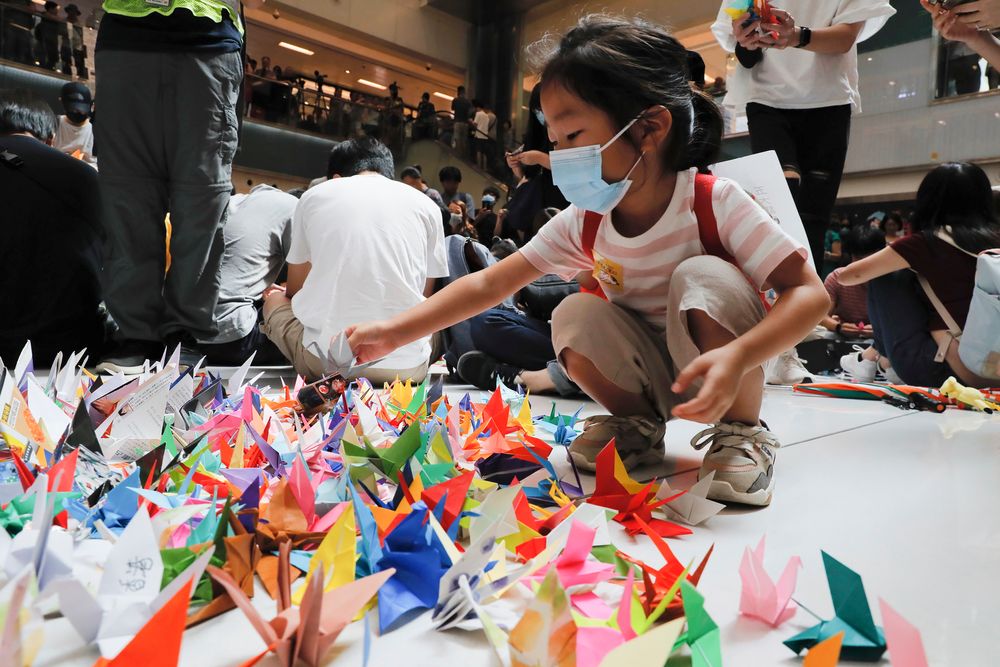 A child arranges origami cranes used in an anti-government rally inside a shopping mall at the Sha Tin district in Hong Kong, Sunday, Sept. 22, 2019. Young protesters, many wearing masks to disguise their identity, filled the open area of a Hong Kong shopping mall Sunday and folded paper A child arranges origami cranes used in an anti-government rally inside a shopping mall at the Sha Tin district in Hong Kong, Sunday, Sept. 22, 2019. Young protesters, many wearing masks to disguise their identity, filled the open area of a Hong Kong shopping mall Sunday and folded paper