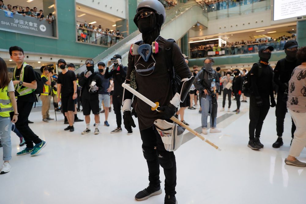 A protester armed with a wooden weapon stands in a mall during a protest in Hong Kong on Sunday, Sept. 22, 2019. Protesters smashed surveillance cameras and electronic ticket sensors in a subway station, as pro-democracy demonstrations took a violent turn once again. (AP Photo/Kin Cheung) A protester armed with a wooden weapon stands in a mall during a protest in Hong Kong on Sunday, Sept. 22, 2019. Protesters smashed surveillance cameras and electronic ticket sensors in a subway station, as pro-democracy demonstrations took a violent turn once again. (AP Photo/Kin Cheung)