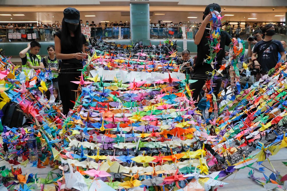 Protesters arranging origami cranes used in a display at an anti-government rally inside a shopping mall at the Sha Tin district, Sunday, Sept. 22, 2019. Protesters in Hong Kong burned a Chinese flag and police fired pepper spray Saturday in renewed clashes over grievances by the anti-government demonstrators. (AP Photo/Vincent Yu) Protesters arranging origami cranes used in a display at an anti-government rally inside a shopping mall at the Sha Tin district, Sunday, Sept. 22, 2019. Protesters in Hong Kong burned a Chinese flag and police fired pepper spray Saturday in renewed clashes over grievances by the anti-government demonstrators. (AP Photo/Vincent Yu)