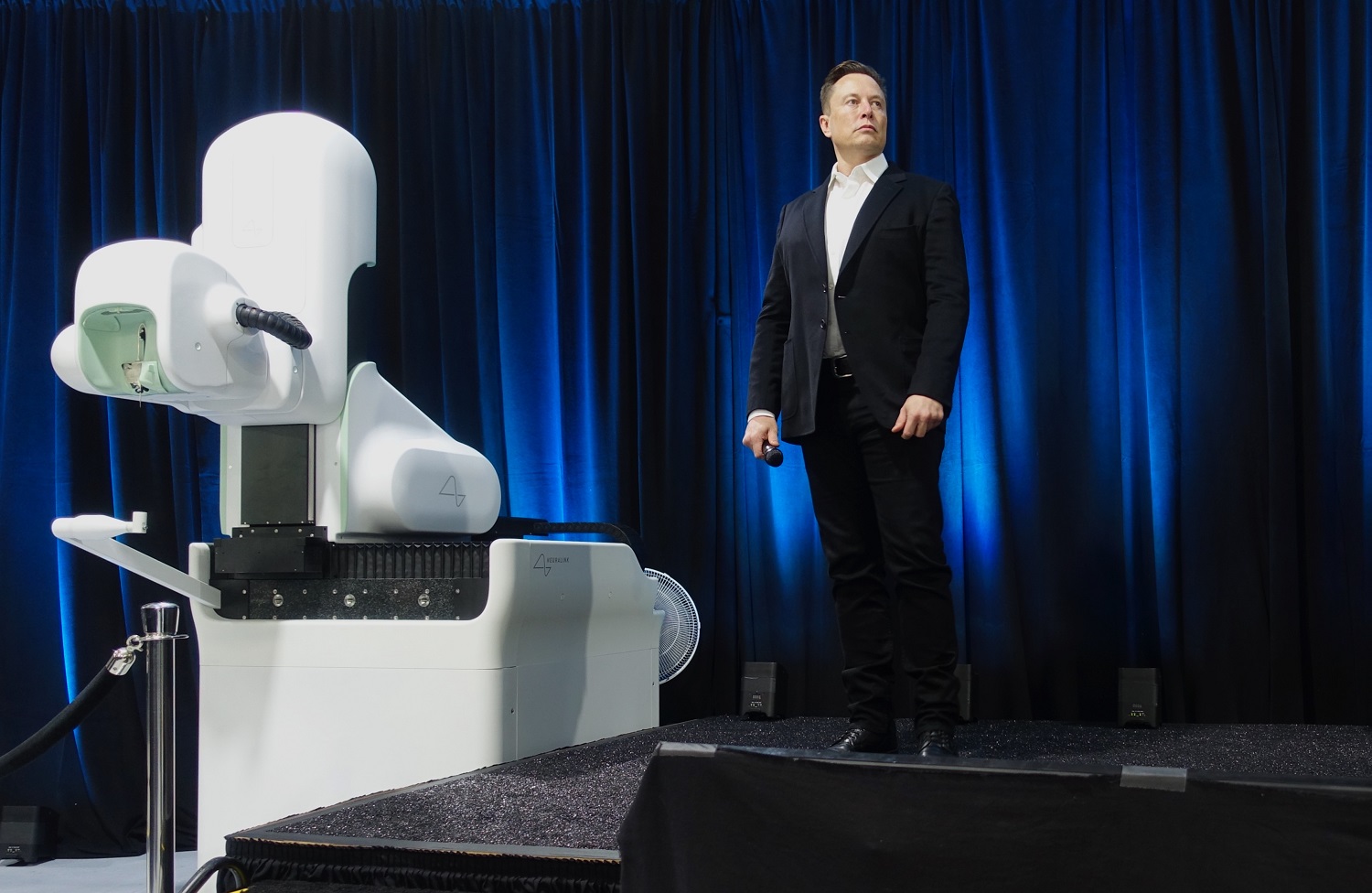 Musk discussing a Neuralink device during a live demonstration in 2020