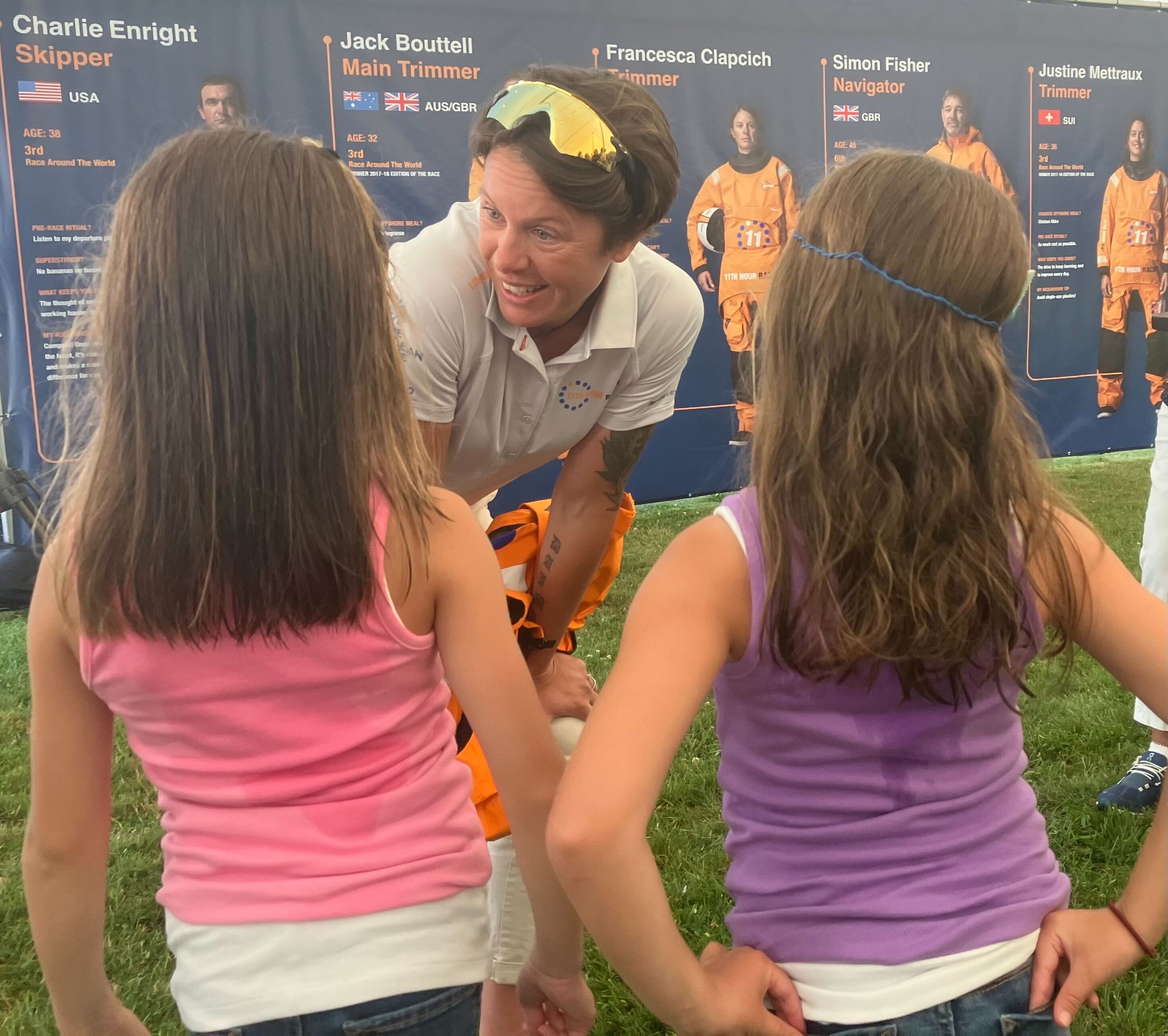 Sailor Francesca Clapcich talks with two fans, Virginia, left, and April Davenport, 7, at the Newport celebration of the victorious 11th Hour Racing team on Friday, August 4, 2023. The team was the first American team to bring home the trophy for the around-the-world Ocean Race in the 50-year history of the event.