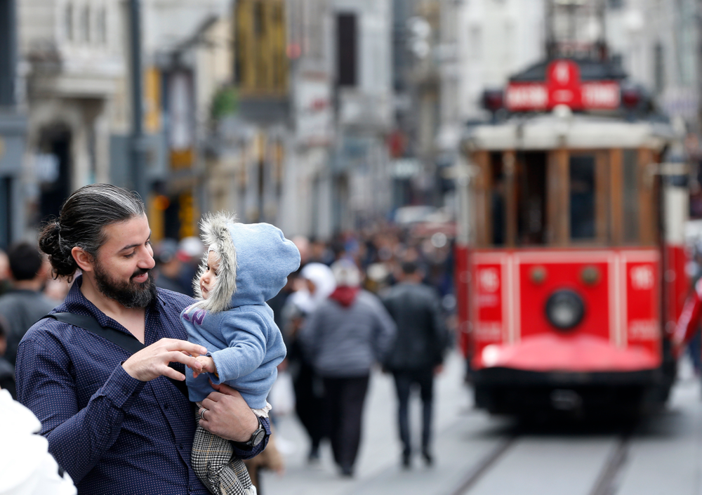In this Thursday, April 4, 2019 photo, a man holds his baby, in Istiklal street, the main shopping street in Istanbul. The mood among opposition supporters in Turkey's biggest city is one of jubilation but also worry - fear that their win in Istanbul's mayoral race could be overturned in a recount taking place after the ruling party challenged the election results. (AP Photo/Lefteris Pitarakis) In this Thursday, April 4, 2019 photo, a man holds his baby, in Istiklal street, the main shopping street in Istanbul. The mood among opposition supporters in Turkey's biggest city is one of jubilation but also worry - fear that their win in Istanbul's mayoral race could be overturned in a recount taking place after the ruling party challenged the election results. (AP Photo/Lefteris Pitarakis)