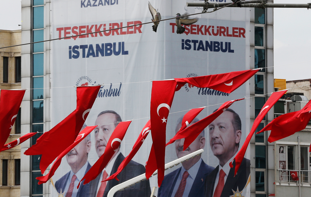 In this Thursday, April 4, 2019 photo, Turkish flags fly in Istanbul Taksim's square while in the background posters showing Binali Yildirim, left, the mayoral candidate for Istanbul of Turkey's President Recep Tayyip Erdogan's ruling Justice and Development Party's (AKP) and Erdogan are seen. The posters reads in Turkish: 'Thank you, Istanbul'. The mood among opposition supporters in Turkey's biggest city is one of jubilation but also worry - fear that their win in Istanbul's mayoral race could be overturned in a recount taking place after the ruling party challenged the election results. (AP Photo/Lefteris Pitarakis) In this Thursday, April 4, 2019 photo, Turkish flags fly in Istanbul Taksim's square while in the background posters showing Binali Yildirim, left, the mayoral candidate for Istanbul of Turkey's President Recep Tayyip Erdogan's ruling Justice and Development Party's (AKP) and Erdogan are seen. The posters reads in Turkish: 'Thank you, Istanbul'. The mood among opposition supporters in Turkey's biggest city is one of jubilation but also worry - fear that their win in Istanbul's mayoral race could be overturned in a recount taking place after the ruling party challenged the election results. (AP Photo/Lefteris Pitarakis)