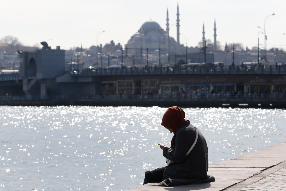 In this Thursday, April 4, 2019 photo, a woman, backdropped by the Suleymaniye mosque, sits by the Golden Horn in Istanbul. The mood among opposition supporters in Turkey's biggest city is one of jubilation but also worry - fear that their win in Istanbul's mayoral race could be overturned in a recount taking place after the ruling party challenged the election results. (AP Photo/Lefteris Pitarakis) In this Thursday, April 4, 2019 photo, a woman, backdropped by the Suleymaniye mosque, sits by the Golden Horn in Istanbul. The mood among opposition supporters in Turkey's biggest city is one of jubilation but also worry - fear that their win in Istanbul's mayoral race could be overturned in a recount taking place after the ruling party challenged the election results. (AP Photo/Lefteris Pitarakis)