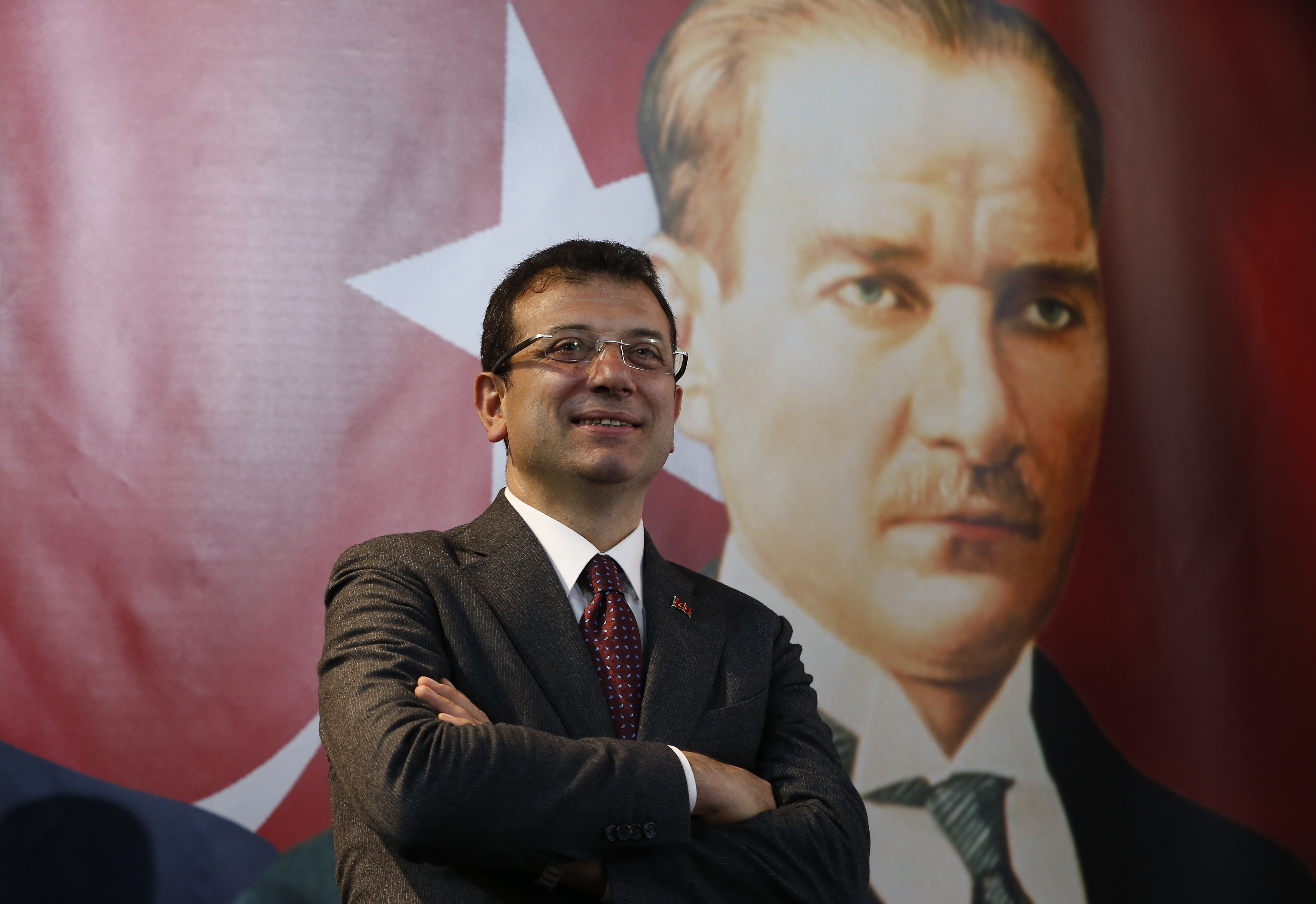 In this Thursday, April 4, 2019 photo, backdropped by a poster of modern Turkey's founder Mustafa Kemal Ataturk, right, Ekrem Imamoglu, the opposition, Republican People's Party's (CHP) mayoral candidate in Istanbul, poses for The Associated Press following an interview in Istanbul. The mood among opposition supporters in Turkey's biggest city is one of jubilation but also worry - fear that their win in Istanbul's mayoral race could be overturned in a recount taking place after the ruling party challenged the election results. (AP Photo/Lefteris Pitarakis) In this Thursday, April 4, 2019 photo, backdropped by a poster of modern Turkey's founder Mustafa Kemal Ataturk, right, Ekrem Imamoglu, the opposition, Republican People's Party's (CHP) mayoral candidate in Istanbul, poses for The Associated Press following an interview in Istanbul. The mood among opposition supporters in Turkey's biggest city is one of jubilation but also worry - fear that their win in Istanbul's mayoral race could be overturned in a recount taking place after the ruling party challenged the election results. (AP Photo/Lefteris Pitarakis)