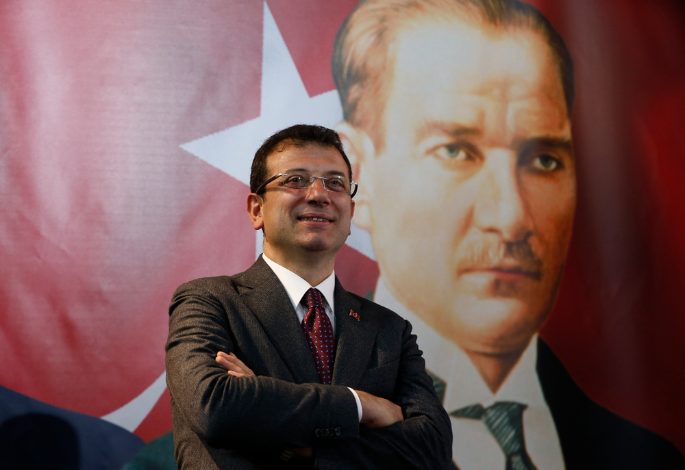 In this Thursday, April 4, 2019 photo, backdropped by a poster of modern Turkey's founder Mustafa Kemal Ataturk, right, Ekrem Imamoglu, the opposition, Republican People's Party's (CHP) mayoral candidate in Istanbul, poses for The Associated Press following an interview in Istanbul. The mood among opposition supporters in Turkey's biggest city is one of jubilation but also worry - fear that their win in Istanbul's mayoral race could be overturned in a recount taking place after the ruling party challenged the election results. (AP Photo/Lefteris Pitarakis) In this Thursday, April 4, 2019 photo, backdropped by a poster of modern Turkey's founder Mustafa Kemal Ataturk, right, Ekrem Imamoglu, the opposition, Republican People's Party's (CHP) mayoral candidate in Istanbul, poses for The Associated Press following an interview in Istanbul. The mood among opposition supporters in Turkey's biggest city is one of jubilation but also worry - fear that their win in Istanbul's mayoral race could be overturned in a recount taking place after the ruling party challenged the election results. (AP Photo/Lefteris Pitarakis)