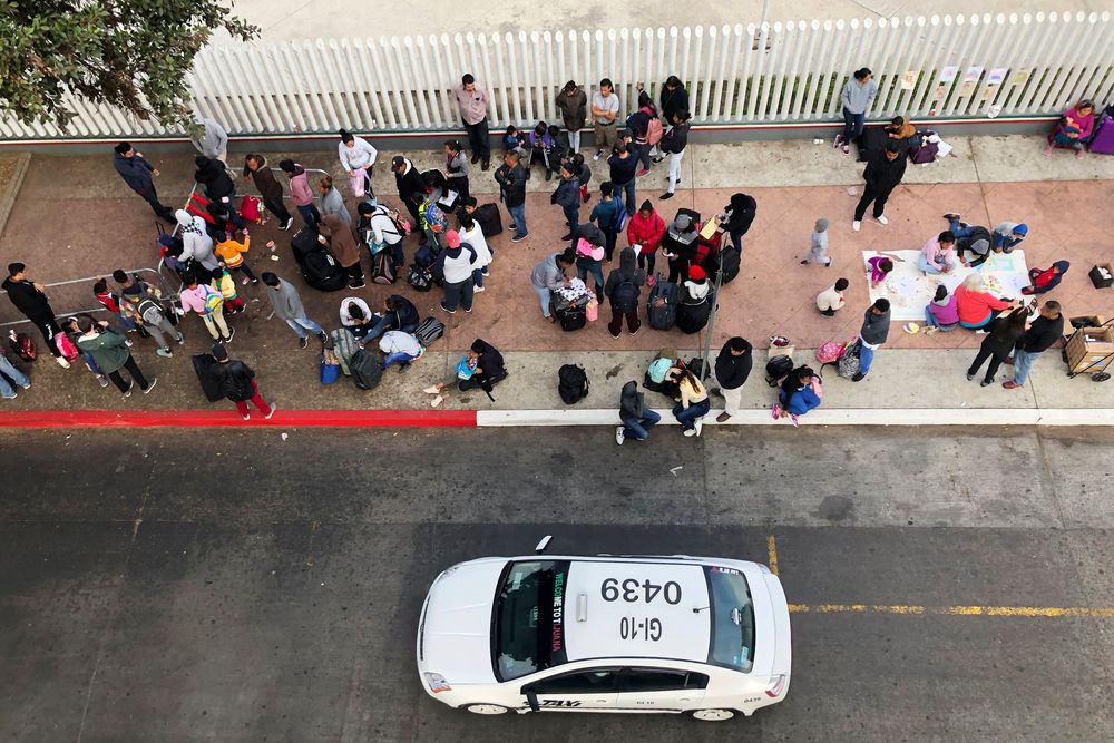 In this Nov. 10, 2019, photo, migrants gather at the U.S.-Mexico border in Tijuana, Mexico, to hear names called from a waiting list to claim asylum in the U.S. The U.S. has sent a Honduran migrant back to Guatemala in a move that marked a new phase of President Donald Trump’s immigration crackdown. (AP Photo/Elliot Spagat) In this Nov. 10, 2019, photo, migrants gather at the U.S.-Mexico border in Tijuana, Mexico, to hear names called from a waiting list to claim asylum in the U.S. The U.S. has sent a Honduran migrant back to Guatemala in a move that marked a new phase of President Donald Trump’s immigration crackdown. (AP Photo/Elliot Spagat)