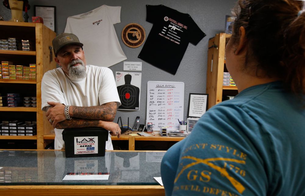 In this photo taken Tuesday, June 11, 2019, Chris Puehse, left owner of Foothill Ammo helps a customer at his shop in Shingle Springs, Calif. Californians will have to undergo criminal background checks every time they buy ammunition starting July 1 under a 2016 voter-approved ballot initiative. (AP Photo/Rich Pedroncelli) In this photo taken Tuesday, June 11, 2019, Chris Puehse, left owner of Foothill Ammo helps a customer at his shop in Shingle Springs, Calif. Californians will have to undergo criminal background checks every time they buy ammunition starting July 1 under a 2016 voter-approved ballot initiative. (AP Photo/Rich Pedroncelli)