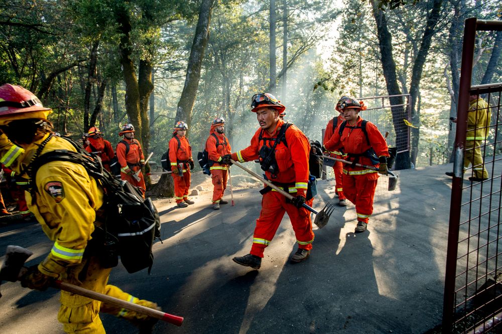 Inmate firefighters battle the Kincade Fire near Healdsburg, Calif., on Tuesday, Oct. 29, 2019. Millions of people have been without power for days as fire crews race to contain two major wind-whipped blazes that have destroyed dozens of homes at both ends of the state: in Sonoma County wine country and in the hills of Los Angeles. (AP Photo/Noah Berger) Inmate firefighters battle the Kincade Fire near Healdsburg, Calif., on Tuesday, Oct. 29, 2019. Millions of people have been without power for days as fire crews race to contain two major wind-whipped blazes that have destroyed dozens of homes at both ends of the state: in Sonoma County wine country and in the hills of Los Angeles. (AP Photo/Noah Berger)