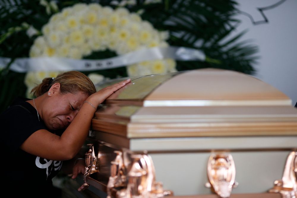 Vanessa Galindo Blas grieves on the coffin that contains the remains of her late husband Erick Hernandez Enriquez, also known as DJ Bengala, who was killed in an attack on the White Horse nightclub where he was DJ'ing, as the family brings his body for burial in the municipal cemetery in Coatzacoalcos, Veracruz state, Mexico, Thursday, Aug. 29, 2019. Vanessa Galindo Blas grieves on the coffin that contains the remains of her late husband Erick Hernandez Enriquez, also known as DJ Bengala, who was killed in an attack on the White Horse nightclub where he was DJ'ing, as the family brings his body for burial in the municipal cemetery in Coatzacoalcos, Veracruz state, Mexico, Thursday, Aug. 29, 2019.