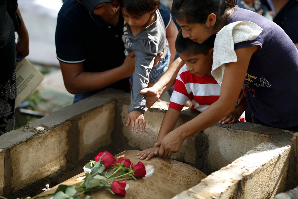 Family members pay their last respects to Maria del Carmen Segovia Padua as they prepare to bury her alongside her aunt Zuleyma Hernandez Sanchez at the municipal cemetery in Coatzacoalcos, Veracruz state, Mexico, Thursday, Aug. 29, 2019. Mexico's President Andres Lopez Obrador insists his go-slow policies of reducing youth unemployment will eventually solve the root causes of violent crime better than declaring another frontal offensive against drug cartels. (AP Photo/Rebecca Blackwell) Family members pay their last respects to Maria del Carmen Segovia Padua as they prepare to bury her alongside her aunt Zuleyma Hernandez Sanchez at the municipal cemetery in Coatzacoalcos, Veracruz state, Mexico, Thursday, Aug. 29, 2019. Mexico's President Andres Lopez Obrador insists his go-slow policies of reducing youth unemployment will eventually solve the root causes of violent crime better than declaring another frontal offensive against drug cartels. (AP Photo/Rebecca Blackwell)