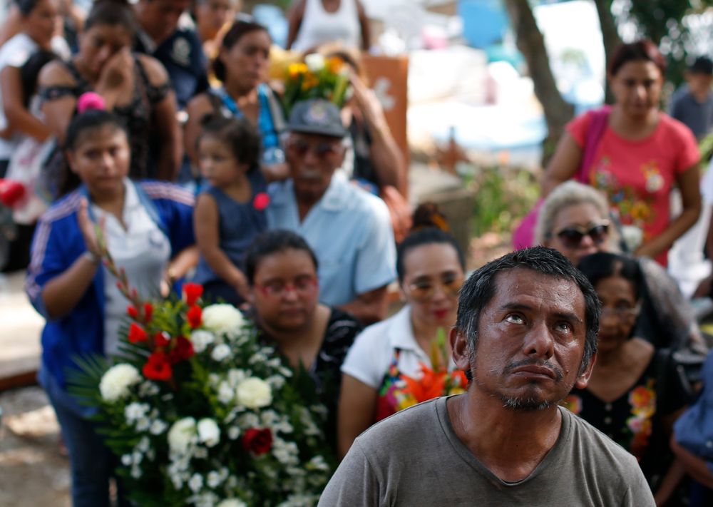 A grieving family member looks to the heavens as mourners bury Maria del Carmen Segovia Padua alongside her aunt Zuleyma Hernandez Sanchez at the municipal cemetery in Coatzacoalcos, Veracruz state, Mexico, Thursday, Aug. 29, 2019. The aunt and niece, who both worked as dancers at the White Horse night club, were among the more than two dozen staff and patrons killed Tuesday night when gang members set the club on fire after blocking the exits. (AP Photo/Rebecca Blackwell) A grieving family member looks to the heavens as mourners bury Maria del Carmen Segovia Padua alongside her aunt Zuleyma Hernandez Sanchez at the municipal cemetery in Coatzacoalcos, Veracruz state, Mexico, Thursday, Aug. 29, 2019. The aunt and niece, who both worked as dancers at the White Horse night club, were among the more than two dozen staff and patrons killed Tuesday night when gang members set the club on fire after blocking the exits. (AP Photo/Rebecca Blackwell)