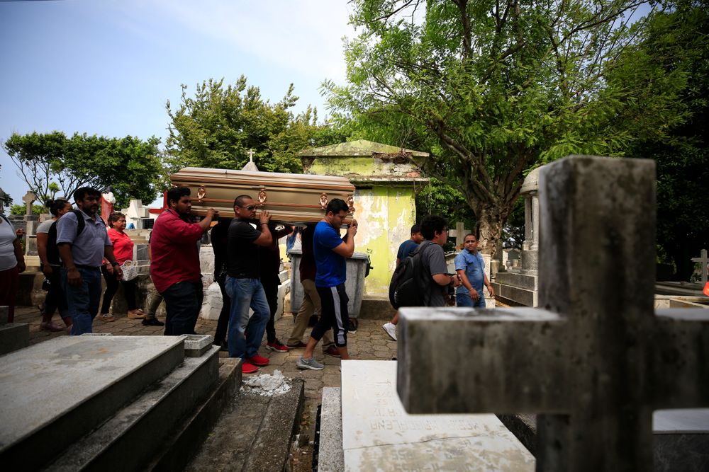 Mourners carry the coffin that contain the remains of Erick Hernandez Enriquez, also known as DJ Bengala, who was killed in an attack on the White Horse nightclub where he was DJ'ing, as they bring him for burial at the municipal cemetery in Coatzacoalcos, Veracruz state, Mexico, Thursday, Aug. 29, 2019. At least seven of the more than two dozen victims were laid to rest in the municipal cemetery Thursday afternoon, in overlapping burials two days after gang members blocked the club's exits and set it on fire. (AP Photo/Rebecca Blackwell) Mourners carry the coffin that contain the remains of Erick Hernandez Enriquez, also known as DJ Bengala, who was killed in an attack on the White Horse nightclub where he was DJ'ing, as they bring him for burial at the municipal cemetery in Coatzacoalcos, Veracruz state, Mexico, Thursday, Aug. 29, 2019. At least seven of the more than two dozen victims were laid to rest in the municipal cemetery Thursday afternoon, in overlapping burials two days after gang members blocked the club's exits and set it on fire. (AP Photo/Rebecca Blackwell)