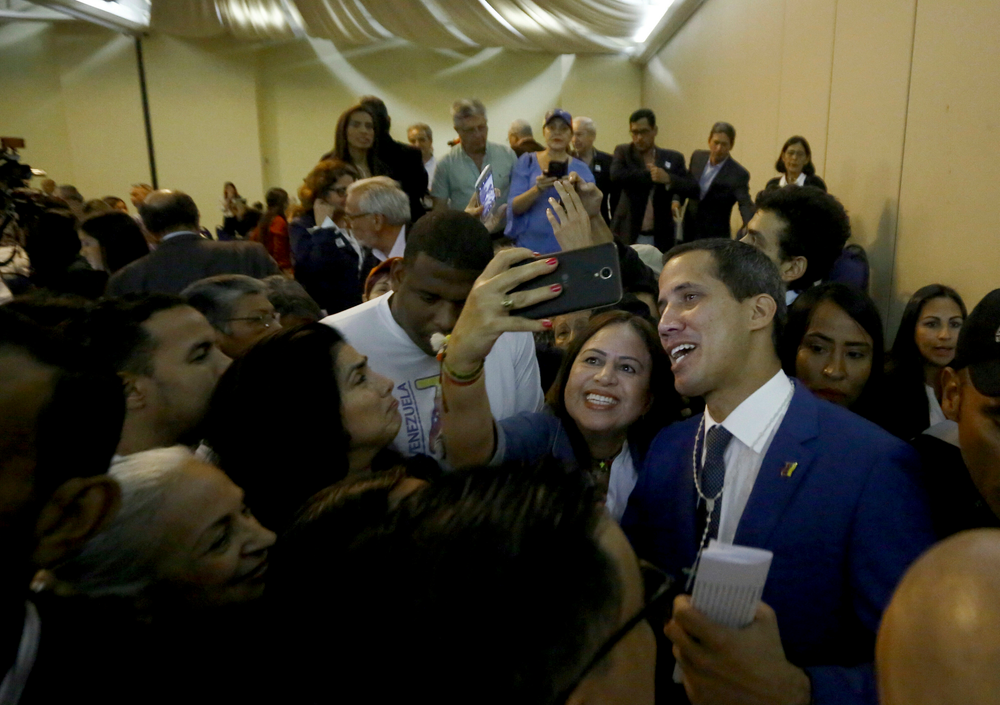 Venezuela's opposition leader and self-proclaimed interim president Juan Guaido, right, poses for selfies with supporters, after a meeting at a hotel in Valencia, Venezuela, June 7, 2019. A member of Venezuela's opposition said that a mediation effort by Norway is stalling over Nicolás Maduro's refusal to accept presidential elections to resolve the nation's political crisis. (AP Photo/Juan Carlos Hernandez) Venezuela's opposition leader and self-proclaimed interim president Juan Guaido, right, poses for selfies with supporters, after a meeting at a hotel in Valencia, Venezuela, June 7, 2019. A member of Venezuela's opposition said that a mediation effort by Norway is stalling over Nicolás Maduro's refusal to accept presidential elections to resolve the nation's political crisis. (AP Photo/Juan Carlos Hernandez)