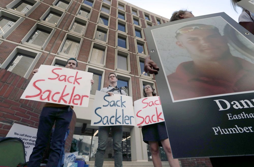 Protesters gather outside a courthouse on Friday, Aug. 2, 2019, in Boston, where a judge was to hear arguments in Massachusetts' lawsuit against Purdue Pharma over its role in the national drug epidemic. Organizers said they wanted to continue to put pressure on the Connecticut pharmaceutical company and the Sackler family that owns it. (AP Photo/Charles Krupa) Protesters gather outside a courthouse on Friday, Aug. 2, 2019, in Boston, where a judge was to hear arguments in Massachusetts' lawsuit against Purdue Pharma over its role in the national drug epidemic. Organizers said they wanted to continue to put pressure on the Connecticut pharmaceutical company and the Sackler family that owns it. (AP Photo/Charles Krupa)