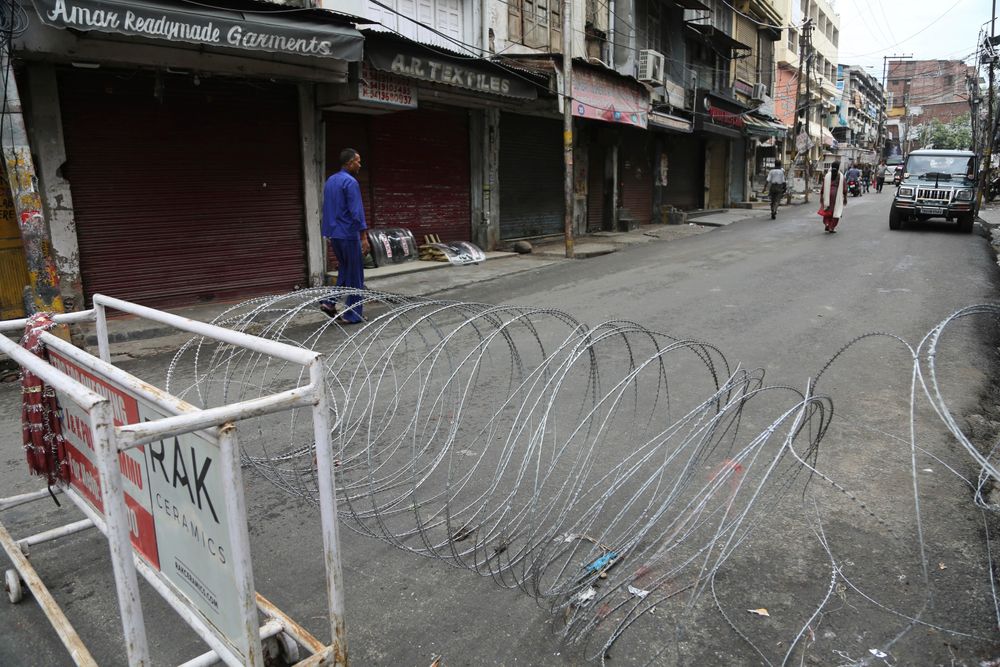 A pedestrian walks past a barbwire barricade set up by security officers in Jammu, India, Wednesday, Aug. 7, 2019. Indian lawmakers passed a bill Tuesday that strips statehood from the Indian-administered portion of Muslim-majority Kashmir, which remains under an indefinite security lockdown, actions that archrival Pakistan warned could lead to war. (AP Photo/Channi Anand) A pedestrian walks past a barbwire barricade set up by security officers in Jammu, India, Wednesday, Aug. 7, 2019. Indian lawmakers passed a bill Tuesday that strips statehood from the Indian-administered portion of Muslim-majority Kashmir, which remains under an indefinite security lockdown, actions that archrival Pakistan warned could lead to war. (AP Photo/Channi Anand)