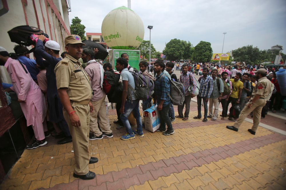 Indian migrant laborers carry their luggage and prepare to leave the region, at a railway station in Jammu, India, Wednesday, Aug. 7, 2019. Indian lawmakers passed a bill Tuesday that strips statehood from the Indian-administered portion of Muslim-majority Kashmir, which remains under an indefinite security lockdown, actions that archrival Pakistan warned could lead to war. (AP Photo/Channi Anand) Indian migrant laborers carry their luggage and prepare to leave the region, at a railway station in Jammu, India, Wednesday, Aug. 7, 2019. Indian lawmakers passed a bill Tuesday that strips statehood from the Indian-administered portion of Muslim-majority Kashmir, which remains under an indefinite security lockdown, actions that archrival Pakistan warned could lead to war. (AP Photo/Channi Anand)