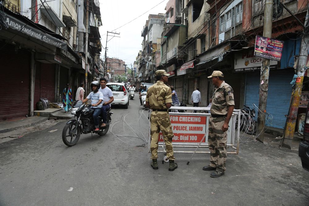 Security officers stand guard near a barricade in Jammu, India, Wednesday, Aug. 7, 2019. Indian lawmakers passed a bill Tuesday that strips statehood from the Indian-administered portion of Muslim-majority Kashmir, which remains under an indefinite security lockdown, actions that archrival Pakistan warned could lead to war. (AP Photo/Channi Anand) Security officers stand guard near a barricade in Jammu, India, Wednesday, Aug. 7, 2019. Indian lawmakers passed a bill Tuesday that strips statehood from the Indian-administered portion of Muslim-majority Kashmir, which remains under an indefinite security lockdown, actions that archrival Pakistan warned could lead to war. (AP Photo/Channi Anand)