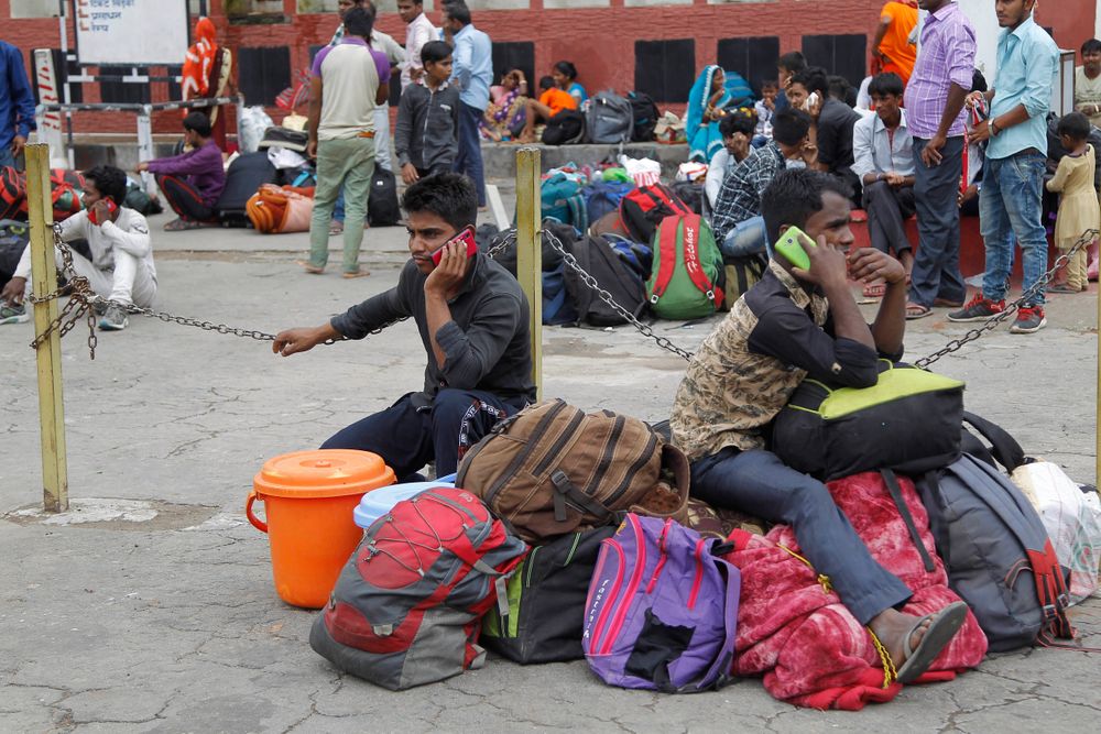 Indian migrant laborers speak on their mobile phones as they prepare to leave the region, at a railway station in Jammu, India, Wednesday, Aug. 7, 2019. Indian lawmakers passed a bill Tuesday that strips statehood from the Indian-administered portion of Muslim-majority Kashmir, which remains under an indefinite security lockdown, actions that archrival Pakistan warned could lead to war. (AP Photo/Channi Anand) Indian migrant laborers speak on their mobile phones as they prepare to leave the region, at a railway station in Jammu, India, Wednesday, Aug. 7, 2019. Indian lawmakers passed a bill Tuesday that strips statehood from the Indian-administered portion of Muslim-majority Kashmir, which remains under an indefinite security lockdown, actions that archrival Pakistan warned could lead to war. (AP Photo/Channi Anand)