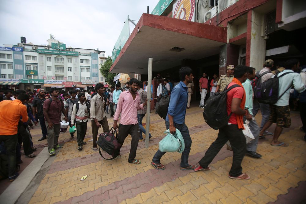Indian migrant laborers carry their luggage and prepare to leave the region, at a railway station in Jammu, India, Wednesday, Aug. 7, 2019. Indian lawmakers passed a bill Tuesday that strips statehood from the Indian-administered portion of Muslim-majority Kashmir, which remains under an indefinite security lockdown, actions that archrival Pakistan warned could lead to war. (AP Photo/Channi Anand) Indian migrant laborers carry their luggage and prepare to leave the region, at a railway station in Jammu, India, Wednesday, Aug. 7, 2019. Indian lawmakers passed a bill Tuesday that strips statehood from the Indian-administered portion of Muslim-majority Kashmir, which remains under an indefinite security lockdown, actions that archrival Pakistan warned could lead to war. (AP Photo/Channi Anand)