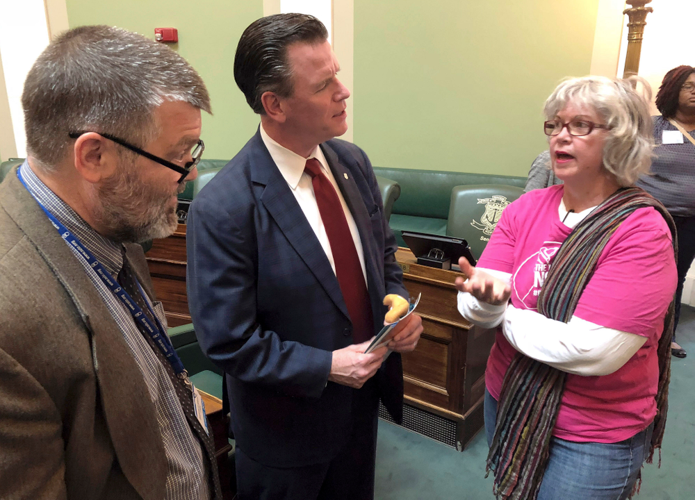 In this Wednesday, May 22, 2019, photo, Democratic State Sen. Stephen Archambault, of Smithfield, center, explains why he voted against a bill to preserve federal abortion protections in Rhode Island state law to Barth Bracy, left, of Rhode Island Right to Life, and San Shoppell, right, of Riverside, a Planned Parenthood volunteer, at the Statehouse in Providence, R.I. Archambault was the swing vote in the Senate Judiciary Committee, which defeated the bill. (AP Photo/Jennifer McDermott In this Wednesday, May 22, 2019, photo, Democratic State Sen. Stephen Archambault, of Smithfield, center, explains why he voted against a bill to preserve federal abortion protections in Rhode Island state law to Barth Bracy, left, of Rhode Island Right to Life, and San Shoppell, right, of Riverside, a Planned Parenthood volunteer, at the Statehouse in Providence, R.I. Archambault was the swing vote in the Senate Judiciary Committee, which defeated the bill. (AP Photo/Jennifer McDermott