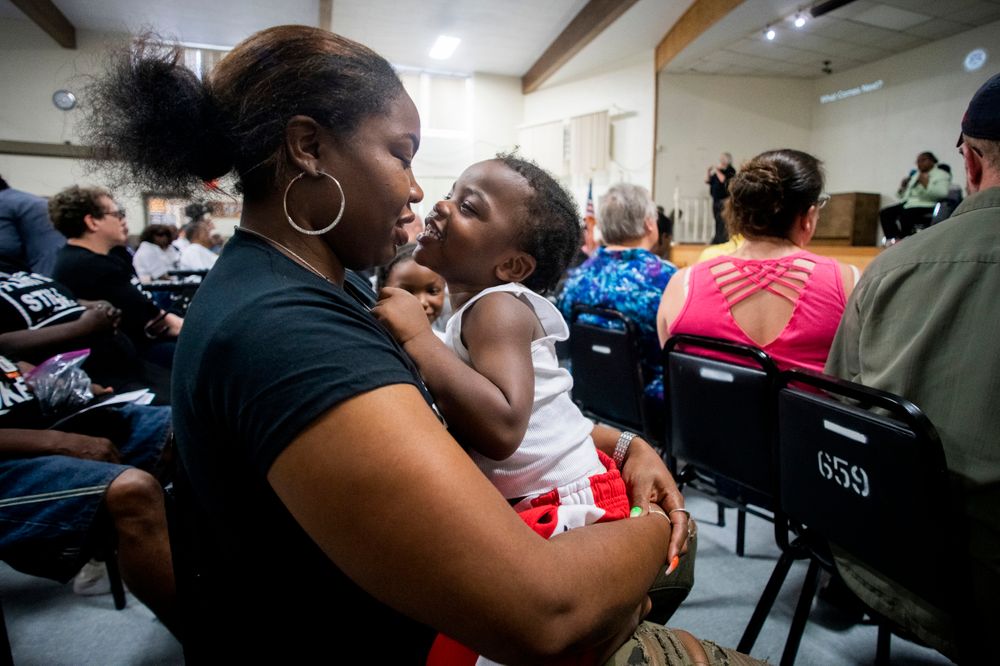 Flint resident Ariana Hawk leans in for a kiss from her 2-year-old, son, Amir, as Wayne County Prosecutor Kym Worthy answers questions from the audience during a community meeting with Flint water prosecutors on at UAW Local 659, Friday, June 28, 2019, in Flint, Mich. Michigan Solicitor General Fadwa Hammoud and Wayne County Prosecutor Kym Worthy spoke to the residents, two weeks after dismissing charges against the former state health director and other officials. (Jake May/MLive.com/The Flint Journal via AP) Flint resident Ariana Hawk leans in for a kiss from her 2-year-old, son, Amir, as Wayne County Prosecutor Kym Worthy answers questions from the audience during a community meeting with Flint water prosecutors on at UAW Local 659, Friday, June 28, 2019, in Flint, Mich. Michigan Solicitor General Fadwa Hammoud and Wayne County Prosecutor Kym Worthy spoke to the residents, two weeks after dismissing charges against the former state health director and other officials. (Jake May/MLive.com/The Flint Journal via AP)
